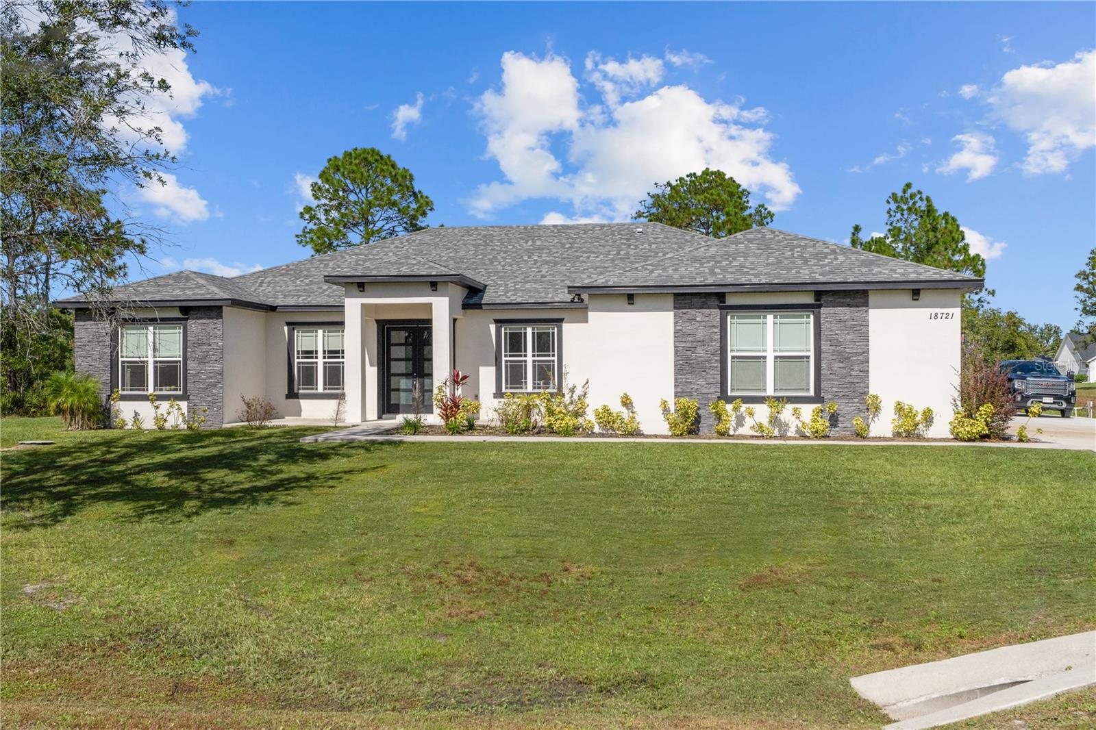 This stunning, newly built Chelsea model is a modern, energy-efficient luxury home nestled on a sprawling 1.24-acre lot in the serene golf and equestrian community of Wedgefield. Offering 2,700 square feet of beautifully designed living space, this 2023 construction seamlessly blends contemporary elegance with ultimate comfort.
The home features 4 bedrooms and 3 bathrooms, an inviting open floor plan, soaring ceilings, and high-end finishes. The chef’s kitchen is outfitted with premium stainless steel appliances, including a cooktop, built-in wall oven, vented canopy hood, and dishwasher, making it a dream for culinary enthusiasts. The primary suite is a private retreat with luxurious amenities and thoughtful design.
Step outside to your backyard oasis, featuring a brand-new 35' x 15' saltwater pool with a quartz finish, a 7' x 7' spa, and a 4" child safety fence for peace of mind. Adjacent to the pool, enjoy a professionally installed 20' x 30' artificial golf putting green, perfect for sharpening your short game. Additionally, the property includes a spacious 830-square-foot oversized three-car garage, ideal for accommodating trucks, boats, ATVs, dirt bikes, and other recreational vehicles. A dedicated 43' x 15' concrete RV pad with 50-amp hookup adds extra convenience for travelers and guests, making this home truly built for adventure and lifestyle flexibility.
With 1.23 acres of usable land, there is ample space to build a future in-law suite, detached workshop, or additional recreational space — offering endless possibilities for multi-generational living or customization. All of this is set within the peaceful Wedgefield community, known for its large private lots, golf course, riding trails, community park, and proximity to Lake Nona, Orlando International Airport, the coast, and major highways.