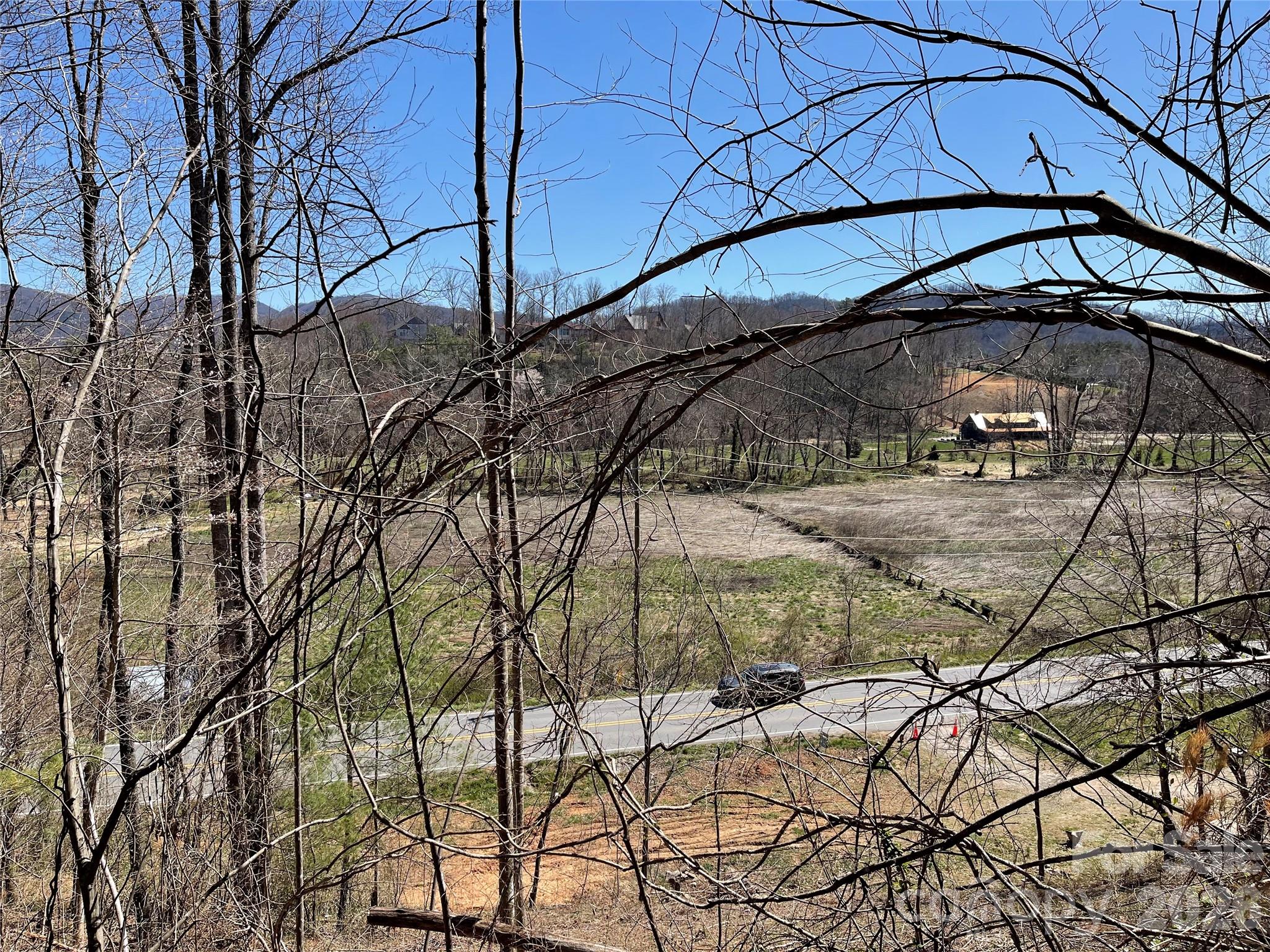 No Deed restrictions. Short term rentals allowed. Commercial, retail, residential, multi-family, r/v park, medical, manufacturing, auto service and sales lot ETC. allowed! Circular road across the top of the property for additional residential or commercial buildings with beautiful 180 degree south views to the mountains with million+ dollar homes across valley. 575 feet of road frontage on Cane Creek Road with multiple entrances and exits. Great site visibility for signage. Previously leased for stain glass studio, medical center/physical therapy, residential studio home, warehouse, auto body, auto sale lot and r/v sites. Currently rented month to month for $1500 (building) and $600 (camper lot). Another camper site available along road and homesite with spectacular view on upper trail. Owner/Broker.