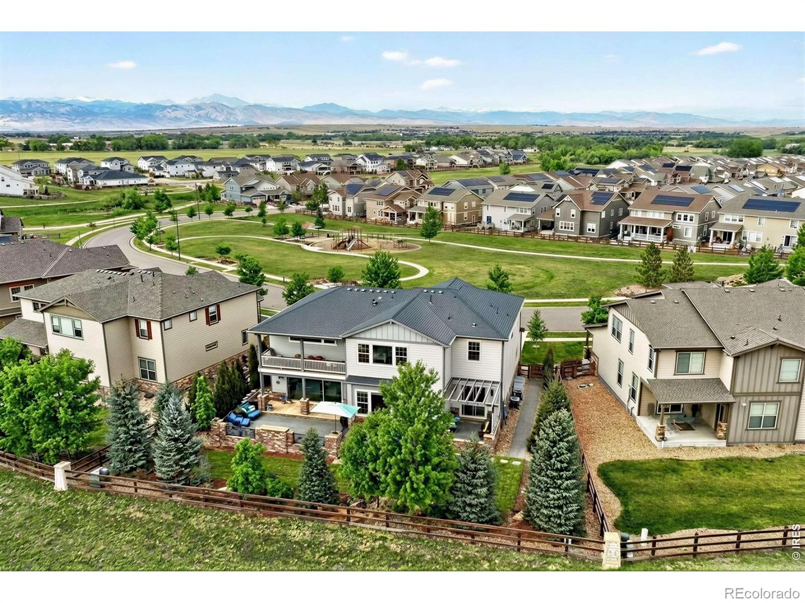 The Parkside Vista Retreat. Perfectly positioned in Flatiron Meadows, this exceptional Toll Brothers Ralson model residence enjoys rare privacy, & mountain views, with no neighbors in front or behind. A charming pocket park anchors the front approach, while serene open space unfolds beyond the backyard, creating a setting that feels expansive & intimate. Meticulously maintained by the original owners, the home reveals thoughtful design at every turn, beginning with a striking knotty alder front door & elegant French doors opening to a home office. Entertain with ease in the formal dining room & the dramatic two-story great room, where a modern gas fireplace, custom hammered metal staircase railing, & a wall of multi-panel telescoping glass doors blur the line between indoors & out. Wide-plank oak hardwood flooring, upgraded interior carpentry, & refined lighting elevate the experience throughout. The chef's kitchen is impressive, featuring a premium appliance package with dual ovens & gas range, an oversized island with bar seating, a walk-in pantry, & a well-appointed butler's pantry. Outdoor living is elevated with a tranquil deck with water feature, gas fire table, dual fire bowls, & a side patio with pergola & garden boxes-an incredibly private, resort-like setting ideal for entertaining. The main level offers a guest suite with walk-in closet, ensuite bath, & direct outdoor access. The finished lower level is designed for gathering, with a spacious rec room, wet bar with beverage fridge, & exceptional storage. Upstairs, a light-filled loft captures unobstructed views, while the primary suite is a true retreat, featuring a large covered private deck, dual walk-in closets, & an expansive spa-style shower. Two additional bedrooms each offer walk-in closets & share a Jack-and-Jill bath. Just blocks from Meadowlark PK-8, surrounded by trails & open space, & close to Boulder, this is a refined yet relaxed lifestyle in one of Erie's most desirable neighborhoods.