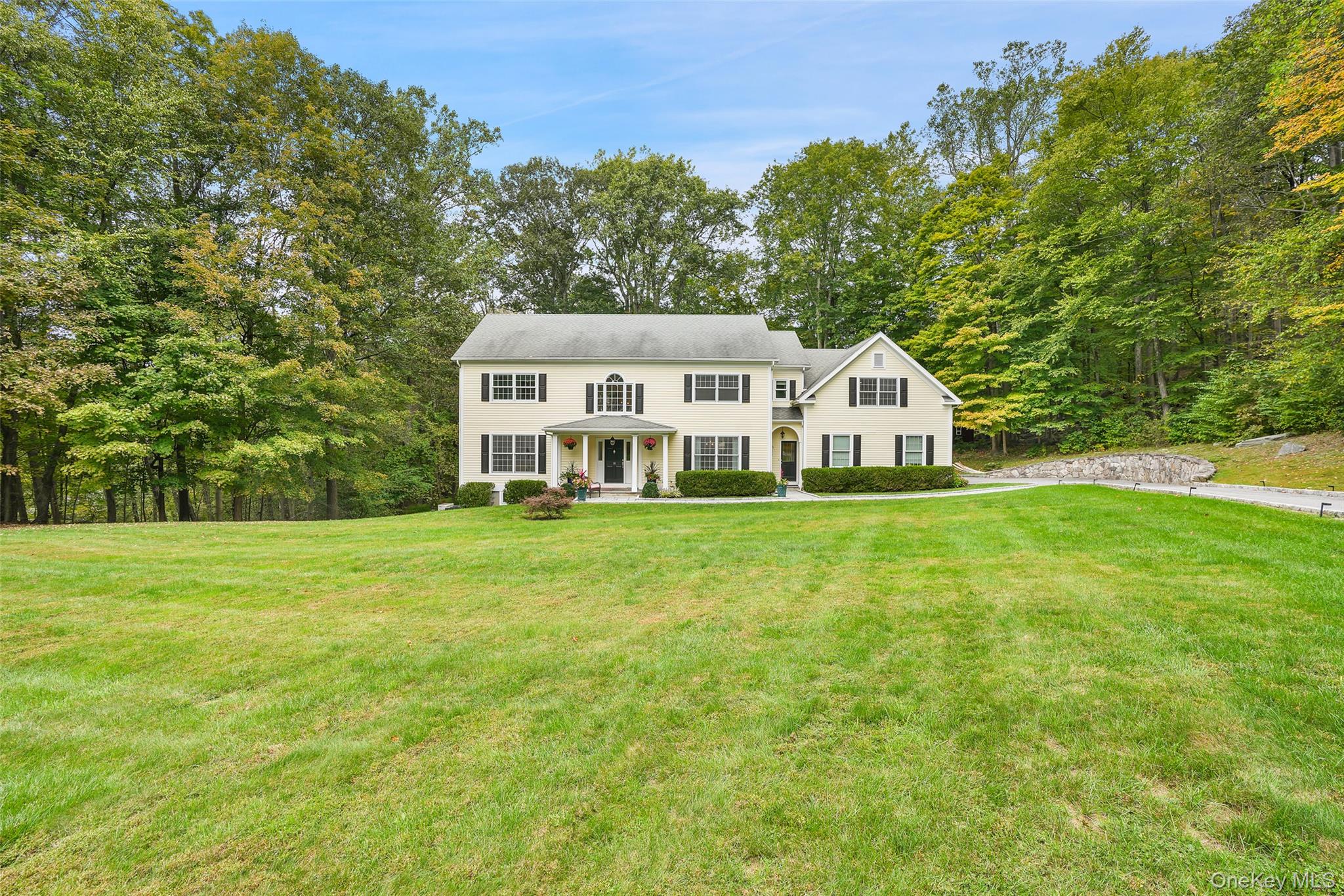 The Perfect Country Colonial. Peaceful setting at the end of a desirable cul-de-sac. Nearly three serene acres with level lawns, flowering plantings, stone walls and towering trees. Fabulous rear terrace with firepit, built-in barbecue and fridge for fun outdoor entertaining. Absolutely turn-key Colonial with light and airy rooms. Stunning interior with great circular flow, high ceilings and beautiful hardwood floors in a dark stain. Dramatic Two-Story Entrance Hall. Formal Living and Dining Rooms. Private Office ideal for working remotely. Chef’s Kitchen open to Family Room with soaring ceiling and gas fireplace. Four Bedrooms including private Primary Suite. Luxurious new Baths. Second Floor Bonus Room with infinite possibilities. Walkout Lower Level. Great Storage. John Jay Schools. An incredible offering!