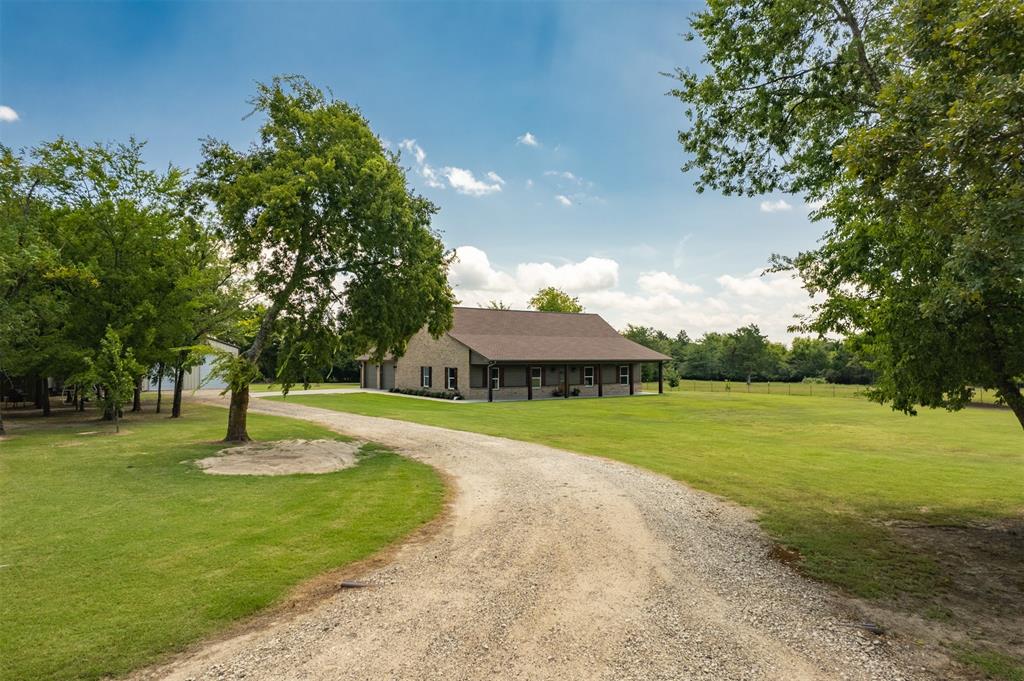 WELL-MAINTAINED CUSTOM 3 bed, 2 bath brick home with 30x30 insulated workshop (with slab, electricity & overhead storage) on 8 acres in the Arbala community and in the Sulphur Springs ISD! Property is completely fenced with security gate at the road. Inside, open concept living is enhanced with 9ft ceilings and crown molding throughout. Gorgeous, warm wood floors give the living areas a seamless elegant look. Kitchen features include a pantry, stainless steel appliances, custom (eat at) bar with beautiful granite that accents the custom built wood cabinets. Split bedrooms with a custom design master bath and other high-end features. Large utility features granite, sink and room for freezer. Outside theres a large covered patio as well as a covered front porch across the entire front of house. Property also has nice shade trees and a pond, fenced and cross-fenced. This place is just the right size for a couple horses, calves, goats and a few chickens. Plenty of room for a garden in the southern Hopkins County sandy soil. Other features include: 2x6 walls, insulated garage with floored storage.  Take a look at this gem that is conveniently located between Lake Fork for great fishing and Sulphur Springs for restaurants, shopping and festivities.