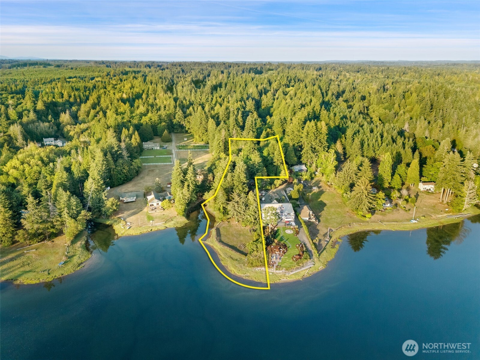 Discover a rare opportunity to own a private waterfront retreat where lifestyle, land, and flexibility come together. Set on 4.6+ acres with over 250 feet of shoreline and owned tidelands, this property invites you to embrace the best of Pacific Northwest living—kayaking from your backyard, harvesting shellfish, and enjoying peaceful sunsets over the water. The home has been thoughtfully updated while maintaining its charm, offering comfortable living spaces filled with natural light and views of the water. Outside, the expansive grounds provide endless possibilities—from gardening and recreation to creating your own legacy estate. A standout feature is the detached shop, offering incredible flexibility for hobbies, storage, or potential ADU use—ideal for multi-generational living or added income. Whether you’re seeking a full-time residence, weekend escape, or future compound, this property delivers space, privacy, and a truly unique waterfront lifestyle.