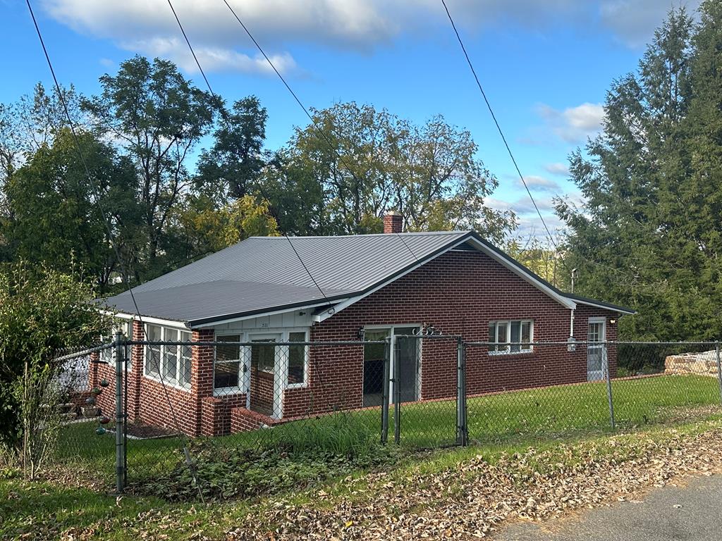 Charming 2-Bedroom Brick Bungalow with Mountain Views - Discover comfort and character in this lovely 2-bedroom (possibly a 3rd bedroom on basement level ) 2-bath brick bungalow, perfectly set to capture stunning mountain views. The home features a bright sunroom and expansive wrap-around decking—ideal for enjoying the outdoors.  walks out to a deck.  An inviting layout with plenty of natural light. The finished room in the basement offers flexible space that could easily be converted into a third bedroom, home office, or guest suite. A dedicated laundry room adds everyday convenience.  This home combines cozy charm with versatile living options—all in a picturesque setting.  Bedroom in basement does not have a closet .  It would also make an excellent private office.
