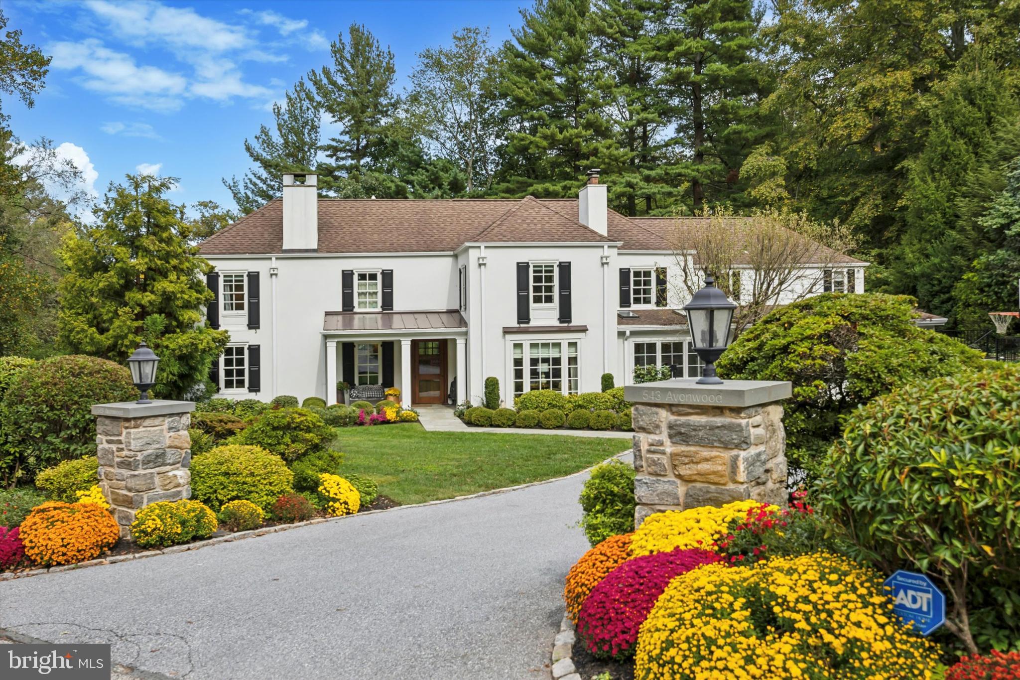 Set along one of North Side Haverford’s most picturesque tree-lined streets in prestigious Lower Merion Township, 543 Avonwood Road is a masterfully updated Colonial that blends timeless Main Line architecture with luxurious modern living. Every inch of this residence has been thoughtfully designed for comfort, sophistication, and effortless entertaining. Originally built with classic Main Line craftsmanship, the home underwent an extensive renovation from 2016 to 2018, reimagined for today’s modern lifestyle while preserving its architectural integrity and charm. Enter through the covered front porch into a welcoming foyer that opens to sunlit, gracefully proportioned interiors enhanced by gleaming hardwood floors, custom millwork, and designer finishes throughout. The gracious living room, centered around a classic wood-burning fireplace, opens to a bright family room with a gas fireplace. The family room flows seamlessly into the formal dining room—perfect for gatherings both intimate and grand. At the heart of the home lies the chef’s kitchen, showcasing a dramatic 10-foot quartzite island, premium stainless-steel appliances, custom cabinetry, and a walk-in pantry. Just off the kitchen, the mudroom offers built-in storage, charging stations, a bench seat, and access to the expanded two-car garage with additional storage. Completing the main level is a handsome den or office featuring custom built-ins and a wood-burning fireplace, along with a stylish powder room off the central hall. Upstairs, the primary suite serves as a true private retreat, featuring a spa-inspired bathroom with a soaking tub and oversized shower, two walk-in closets, and a custom-fitted gym ideal for wellness and relaxation. Two well-sized bedrooms share a full hall bath, while an additional bedroom enjoys its own en suite bath. Off the back staircase, a spacious bedroom and bath provide a perfect guest or au pair suite. A conveniently located laundry room sits just off the primary suite. The finished lower level, complete with custom built-ins, offers versatile living space ideal for a media room, playroom, or home office, along with abundant storage and mechanicals. Outside, the property transforms into a private resort oasis—complete with a heated pool and integrated spa, surrounded by lush landscaping and an expansive stone patio designed for al fresco dining and effortless entertaining. Located within the highly sought-after Lower Merion School District, this exceptional home offers the very best of Main Line living—just moments from Haverford Station, Suburban Square, Merion Cricket Club, and award-winning schools. Combining timeless architecture and a premier location, 543 Avonwood Road is a rare opportunity to own a truly turn-key residence in one of Haverford’s most coveted neighborhoods.