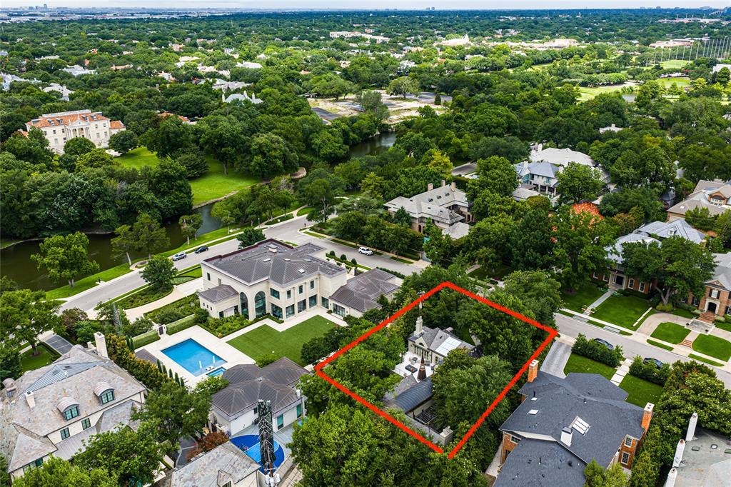 This Highland Park home is a rare gem on the highly sought-after estate block of Gillon Avenue. The very first property adjacent to Lakeside Drive and Exall Lake on Turtle Creek, 0.437 acres, it boasts 96 feet of frontage framed by mature trees and meticulous landscaping - an amazing building custom building site or expansion opportunity. Remodeled by JK Boone, this residence showcases exquisite flooring, custom millwork, and incredible art walls. A unique feature is the dual primary suite layout, one that offers a private terrace overlooking the serene rear grounds. High ceilings and generous room proportions create an inviting ambiance. Outside, a beautifully landscaped yard includes an outdoor living area with a fireplace in addition to the pool area with Pennsylvania stone hardscaping, a fountain, and a commercial pizza oven. Above the detached two-car garage is a 464 square-foot guest suite or quarters with elevator access. This property combines impeccable craftsmanship with a sterling location making it an incredible opportunity to utilize the existing home and improvements, or embark on a new chapter using the commanding street presence and exceptional location for your new build opportunity in the heart of Highland Park.