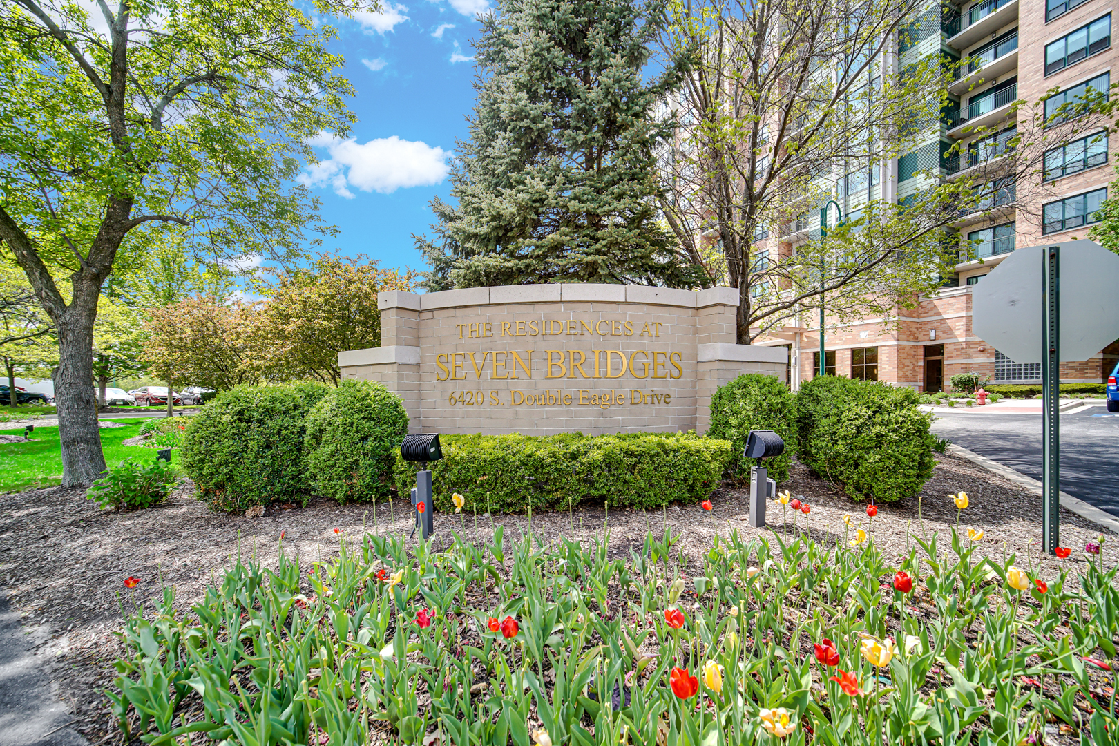This move-in-ready luxury condo offers the perfect blend of modern upgrades, comfort, and full-service living. Featuring 3 spacious bedrooms and 2 baths. The home is enhanced by soaring 9-foot ceilings and rich hardwood floors throughout, creating a warm and elegant atmosphere.  The beautifully updated kitchen, is designed to impress with sleek quartz countertops, warm wood cabinetry, and a full suite of stainless-steel appliances-ideal for both everyday living and entertaining. Each bathroom has been refreshed with newer vanities, quartz countertop, lighting and plumbing fixtures, offering a clean and contemporary feel. The primary suite serves as a private retreat, complete with a professionally organized closet system for optimal storage and convenience.  Set within a full-amenity building, residents enjoy the ease of a 24-hour doorman, a refreshing outdoor pool, and a well-appointed party room perfect for gatherings. The unit includes both a deeded garage space and an additional outdoor parking spot-an exceptional convenience. Additional features include a large private storage unit and dedicated bike storage.  Ideally located just steps from Seven Bridges golf course, health club, movie theater, and a wide variety of dining options, this home offers not only luxury living but also unmatched access to recreation and entertainment right outside your door.