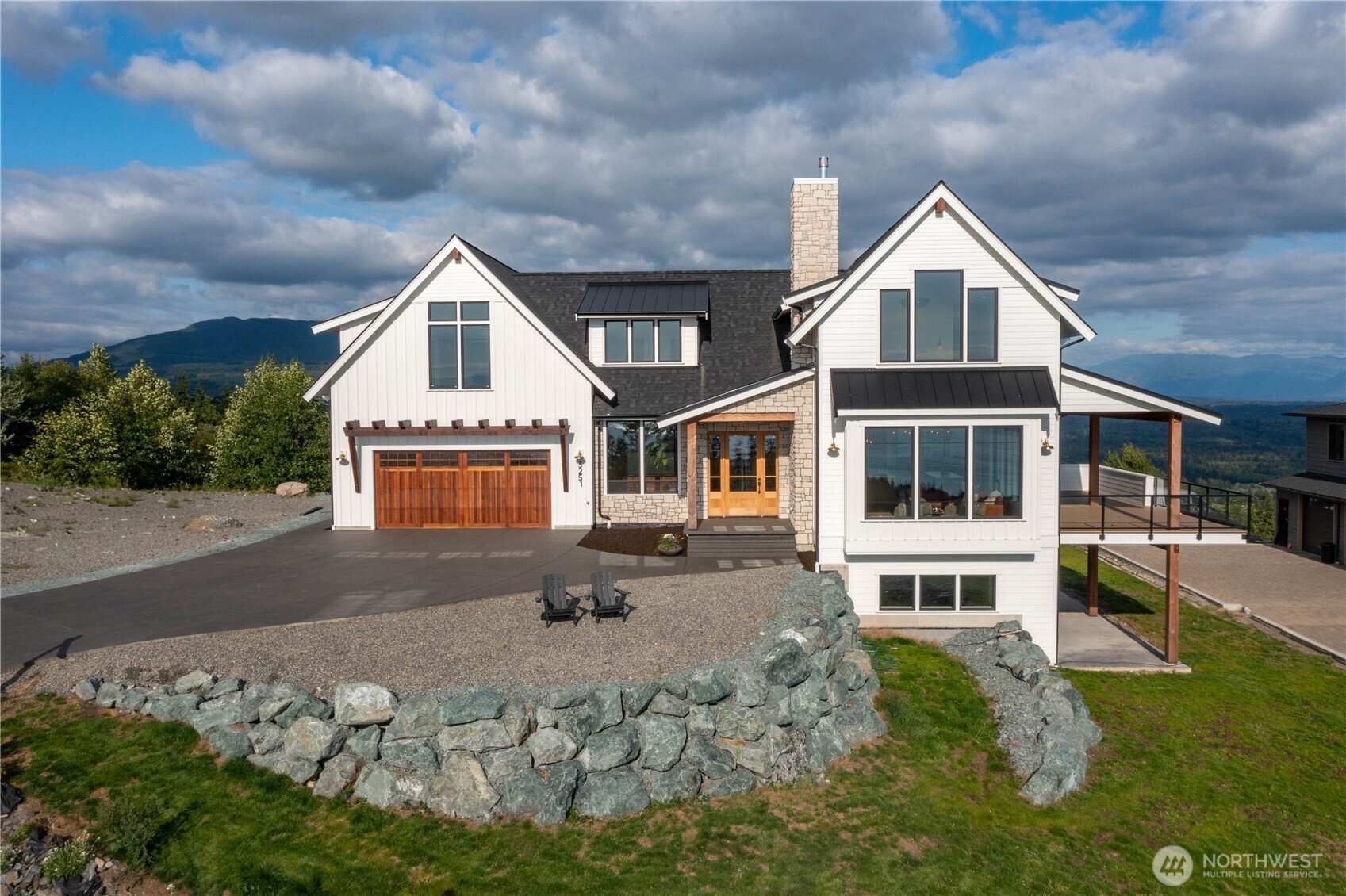 Experience elevated living in this exceptional new construction home in private gated community of Chuckanut Scenic Estates. Ideally positioned on a .9 acre parcel, this stunning, 5,331 SF residence offers panoramic views of Skagit Valley, Padilla Bay, the San Juan Islands & the Olympic Mountains, truly a rare 365-degree vantage point. Designed with both luxury & functionality in mind, the main level showcases an open-concept great room with soaring ceilings, reclaimed wood accents & expansive windows that frame the incredible scenery from every angle. Chef’s kitchen features marble countertops, high-end appliances & beautiful custom cabinetry, seamlessly flowing into the dining & living areas. Step outside to the covered deck with built-in heat lamps, perfect for year-round enjoyment. Office completes the main level. Upstairs, the primary suite is a true retreat with vaulted ceilings, awe-inspiring views, spa-like ensuite & generous walk-in closet. 2 more bedrms & bathrm complete the upper level. Lower level offers spacious family room, 4th bedroom, full bath, bonus/rec room ideal for gym, flex space or storage. Highlights include engineered hardwood floors, heat pump providing both heating & A/C & ADU above the garage with its own private entrance. Adjacent to a conservation easement, enjoy added privacy & natural setting with no home to one side. Plat abuts State land with access to tons of trails! Rare opportunity to own a one-of-a-kind luxury home with unmatched views.