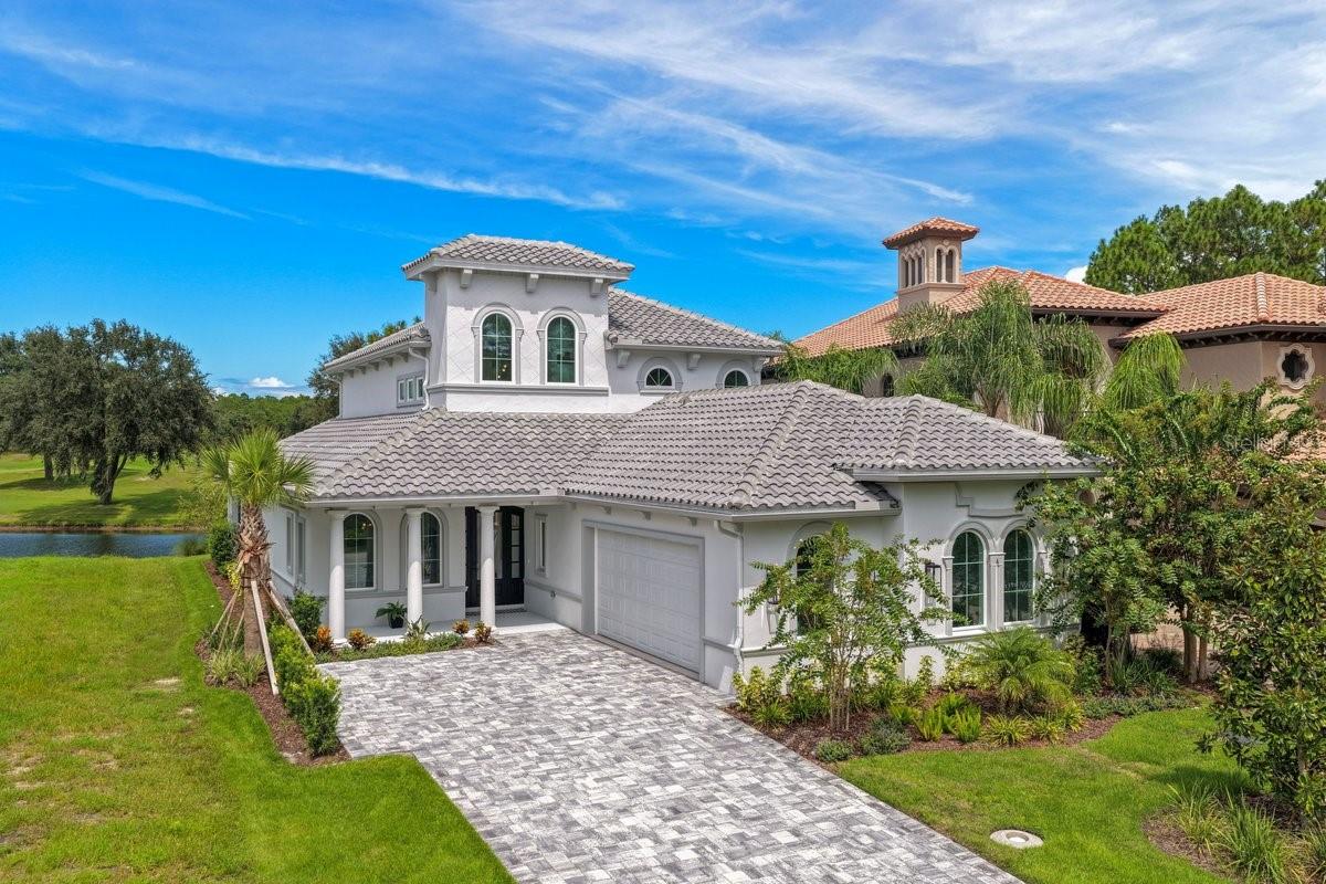 Why wait to build when your dream home is already here? Discover an extraordinary brand-new custom residence in The Conservatory at Hammock Beach, where timeless architecture, elevated craftsmanship, and breathtaking golf and water views come together in an exceptional setting. Perfectly positioned on one of the community’s most desirable lake-to-golf-course homesites overlooking Hole #6, this remarkable 3,041-square-foot residence offers four bedrooms and three bathrooms, with every detail thoughtfully curated to create a luxurious yet inviting coastal retreat.From the moment you arrive, the home makes a statement. A dramatic grand entry featuring a soaring clerestory and open-to-below design fills the space with natural light and creates an impressive sense of volume. Beautiful luxury LVP flooring extends throughout the main living spaces and bedrooms, while the open-concept design effortlessly brings together the living room, dining area, and spectacular chef’s kitchen—creating an elegant backdrop for intimate gatherings or unforgettable entertaining.The kitchen is truly the heart of this home, where exceptional materials meet impeccable design. Custom white oak cabinetry features soft-close dovetail drawers, decorative hardware, and integrated cabinet lighting, beautifully complemented by luxurious Taj Mahal quartzite countertops and premium GE Café appliances. A custom dry bar with bespoke shelving and a dedicated bar refrigerator provides the perfect finishing touch for entertaining and everyday indulgence.Wake each morning to sweeping golf and water views from the serene main level primary suite, designed as a private retreat from the world. The spa-inspired primary bath elevates everyday living with dual vanities and an extraordinary oversized walk-in shower featuring a freestanding soaking tub beautifully positioned within the enclosure. The main level also offers a refined library or private office, guest bedroom, full bath, and thoughtfully designed laundry room, providing exceptional flexibility for both everyday living and visiting guests.Upstairs, the experience continues with an expansive bonus room showcasing panoramic views across the golf course and lake. Step onto the private balcony, where a custom decorative railing frames the scenery and creates an idyllic setting for morning coffee, evening cocktails, or sunset gatherings. It is a space designed not simply to be enjoyed, but to be remembered.Throughout the residence, custom details reveal the level of thought and craftsmanship invested in the home, including built-out closet systems, custom stair lighting, elegant porcelain tile in every bathroom, and dedicated A/C systems for each level. A side-entry two-car garage completes the home with both style and functionality. Best of all, this is luxury without the burden of high-maintenance living. The HOA includes lawn care, irrigation, fiber-optic internet, and a manned security gate, allowing you to spend less time on upkeep and more time enjoying the lifestyle.Residents may also choose to embrace the resort-inspired Hammock Beach Club amenities available with membership within the community, including clubhouse, golf, pool, and fitness facilities. And with a one-year from CO builder warranty included, this exceptional property offers the rare opportunity to be the very first to experience everything it has been designed to provide. This is more than a new home—it is a statement of refined living.