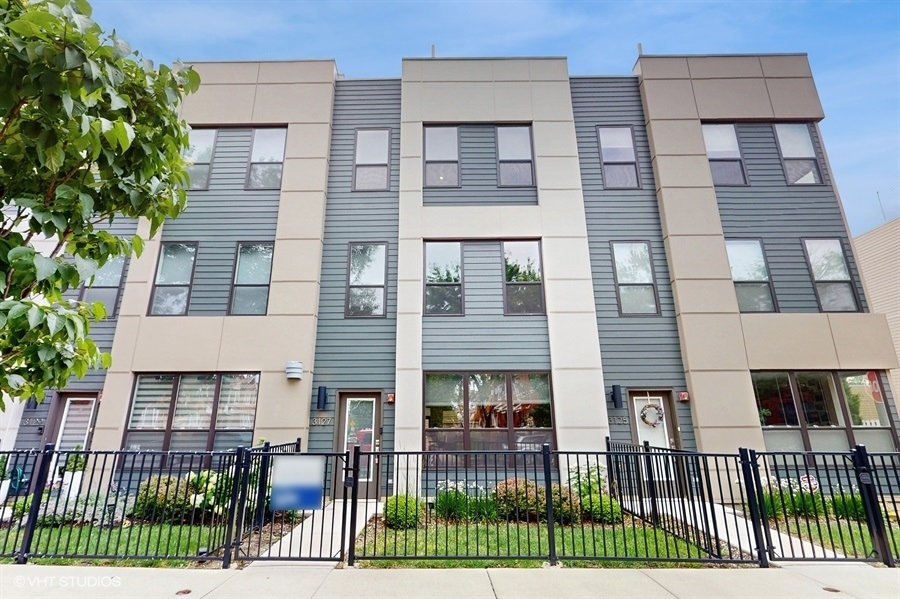 Freshly Paint  Modern Luxury in the Heart of Avondale'  Welcome to this stunning new construction townhome (built in 2020) nestled on a quiet, tree-lined, one-way street just off Belmont and Pulaski. This four-level gem lives like a single-family home and offers nearly every modern convenience in one of Chicago's most vibrant neighborhoods.  Step inside to find 9-foot ceilings throughout, and an open-concept main floor flooded with natural light and wide-plank engineered hardwood floors. The spacious Living and Dining areas seamlessly flow into a chef's kitchen featuring an oversized island with waterfall quartz countertops, upgraded stainless steel appliances, a gas range, and custom backsplash-ideal for entertaining or everyday cooking.  Just off the kitchen, step into your private, fenced backyard, designed for low maintenance and quiet enjoyment. A stylish Powder Room, custom mudroom area, and private two-car garage complete the first floor.  The second level offers two large bedrooms with plush carpeting, a full bath, and a laundry room roomy enough for folding and storage.   Head up to the 3rd level to discover your private ensuite retreat with dual vanities, an oversized shower with built-in bench, and a generous walk-in closet. A second Living Room on this level provides a perfect flex space for relaxing, working, or unwinding in privacy.  The top floor features a private rooftop deck with breathtaking views of the Chicago skyline to the east and sunset vistas to the west-a true urban oasis.  Located within walking distance of Kosciuszko Park, two Blue Line stops, the Metra, and I-90, this home offers unbeatable convenience. Enjoy local favorites like Avondale Music Hall, Sleeping Village, Mother's Ruin, Void, Deep Red Wine, Starpolska, Warlord, Central Park Bar, and Moonwalker Cafe, all just steps away