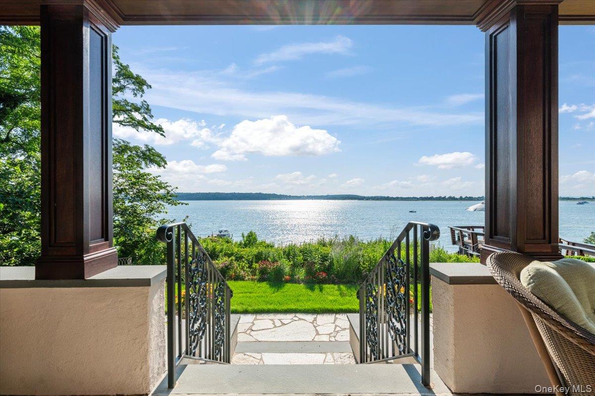 Immerse yourself in this stunning waterfront villa on Centre Island. Although newly rebuilt inside and out, the original character of this 1929 colonial creates an amazing synergy between modernity and history. Perched comfortably above the bay, the backyard slopes gracefully towards the water's edge with a new seawall. The professional landscape plan not only created beautiful grounds, but a number of entertaining and play areas, including a dining terrace with built-in barbeque/prep station.  On the eastern side of the home, you are met by a sizeable driveway and a separate two car garage. Upon entering the front door, a beautiful onyx kitchen welcomes you. The charming dining room anchored by its fireplace, French doors face west, allowing you to take in the spectacular views. The cozy living room and its complementary fireplace. Through large French doors is an inviting covered terrace, making it the perfect place to entertain guests, or for intimate moments looking at sunsets over the bay. In addition to the stairs, all floors are accessible via a new elevator. The grand master bedroom comes complete with two large fully outfitted closets and a spa quality bathroom with unparalleled water views from shower and tub. A private balcony off the master offers the perfect place to enjoy a sunset or morning coffee. There are two additional bedrooms, a marble bath, and a small office on the second floor.  The perfect weekend getaway or main residence this Centre Island home offers a turnkey option for any waterfront buyer could want.  Truly A One-Of-A-Kind! Call For Details.