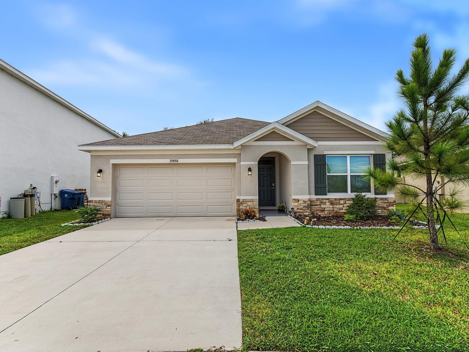 Welcome to 10668 Quail Grove Way, a beautifully upgraded 2024-built home located in the highly desirable Mirada community. This move-in-ready residence offers 3 bedrooms, 2 full bathrooms, a two-car garage, and a spacious driveway for additional parking.Inside, the thoughtfully designed open-concept floor plan seamlessly connects the kitchen, dining area, and living room, creating a bright and inviting space for everyday living and entertaining. The owners have replaced the original carpeting with stylish luxury vinyl plank flooring, added a modern kitchen backsplash, and installed a glass shower enclosure in the primary bathroom.Step outside to enjoy the fully fenced backyard featuring low-maintenance vinyl privacy fencing and no direct rear neighbors. The home is ideally positioned along a peaceful, low-traffic section of the street and just steps from a community walking trail.Living in Mirada means enjoying an exceptional resort-style lifestyle centered around its spectacular 15+ acre crystal-blue MetroLagoon. Residents can swim, kayak, paddleboard, relax along the sandy shoreline, enjoy a vibrant year-round calendar of community activities, special events and explore miles of walking and biking trails.This home combines modern construction, valuable upgrades, added privacy, and access to one of Tampa Bay’s most distinctive communities. Schedule your private showing today and experience the Mirada lifestyle!
