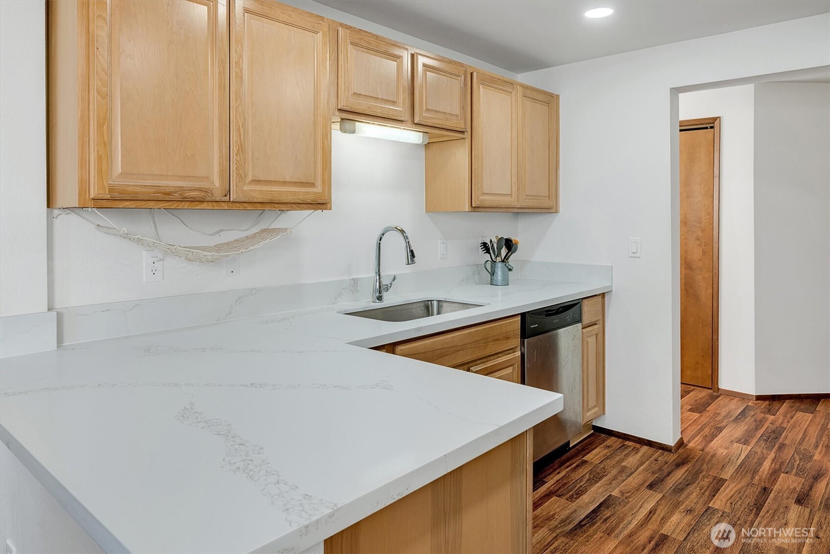 Waterfront living! Easy access to this 1st floor (no steps) spacious with bright windows and lots of updates. Walk down to the water and experience the Puget Sound from your own backyard on Oyster Bay. Entertain, cook, and gather in a beautifully updated kitchen featuring new white quartz countertops, solid wood cabinetry, and premium stainless-steel appliances, including a built-in oven and microwave. Enjoy the serene views of the mountains and the sound from balconies off the living room and the primary bedroom. Gather around the charming brick fireplace, the glowing heart of this spacious living room. 2 assigned covered parking spots and additional (252 SqFt) storage room in the parking garage. No Rental cap. Bring your Cash offer