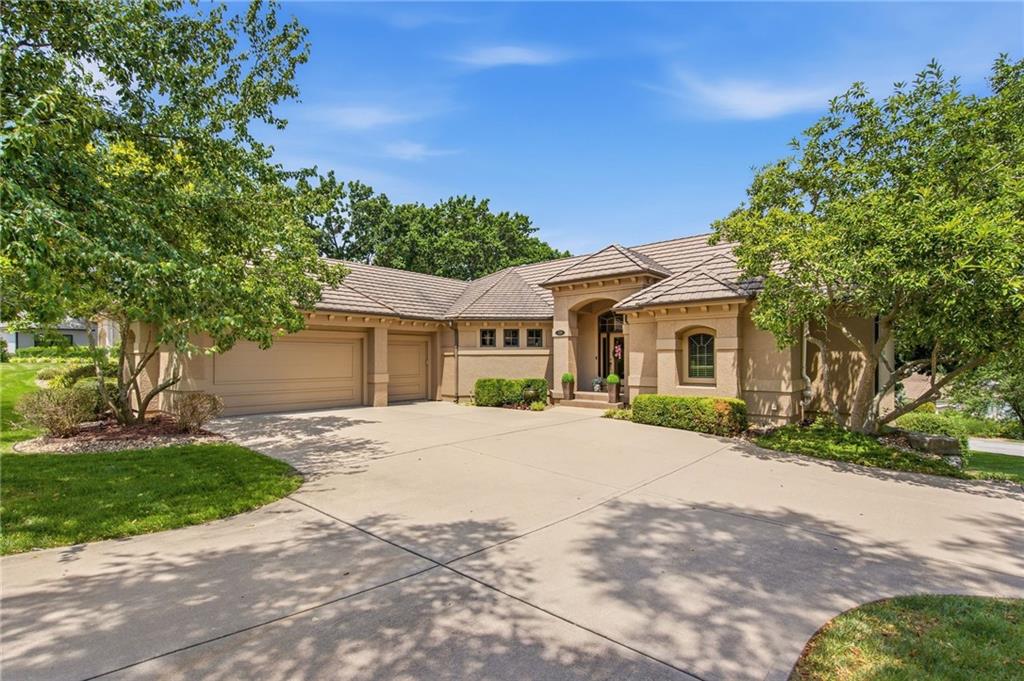 Elegant Lake Winnebago Villa. Experience exceptional low-maintenance living in this stunning 4,100+ sq ft villa thoughtfully designed with timeless elegance & refined finishes. You’ll appreciate the soaring ceilings, extensive crown molding, rich hardwood floors, and exceptional attention to detail. The beautifully appointed gourmet kitchen is the heart of the home, featuring an oversized island, walk-in pantry, abundant cabinetry, and generous counter space. Designed to bring the outdoors in, the open living spaces are filled with natural light and offer a seamless connection to nature. Step onto the covered deck with vaulted ceiling, fan, and peaceful lake views—the perfect setting for morning coffee or evening relaxation. The main level is designed for everyday luxury with a private office featuring custom built-ins, a spacious laundry room w/ sink, cabinetry, and hobby area, a drop zone, and a large 3-car garage with epoxy flooring. The formal living room provides a space for entertaining or quiet relaxation. The expansive owner’s suite offers a private retreat with a raised ceiling accented by crown molding and a spa-inspired ensuite featuring a double vanity, walk-in shower, whirlpool tub, and generous walk-in closet. The finished walkout lower level is ideal for a family or hosting friends with a spacious family room, wet bar, fireplace, and three additional bedrooms and two bathrooms. Step outside to a private patio surrounded by beautiful landscaping and mature trees. Enjoy lake views just steps from resort-style amenities, including the villa swim dock and community boats. Home includes its own private golf cart—perfect for cruising to the dock, pool or AYC. The Villa HOA provides lawn care, leaf removal, community boat dock access, and use of 2 pontoon boats. Enjoy Lake Winnebago lifestyle with boating, sailing, fishing, water skiing, wakeboarding, tennis, pickleball, pool, and dining at Arrowhead Yacht Club.
