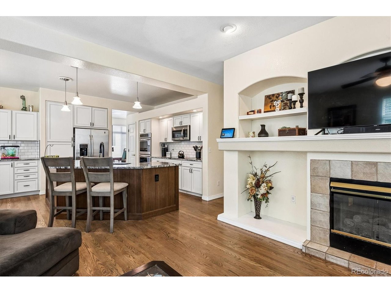 Don't miss seeing one of the best values in Stonegate!  Nestled in the highly sought-after Stonegate community of Parker, this beautifully updated single-family home offers the perfect blend of comfort, style, and functionality. Designed with an open and inviting floor plan, the home is filled with natural light from numerous expansive windows, creating warm and welcoming living spaces throughout. At the heart of the home is the stunning remodeled kitchen, truly a chef's dream, featuring beautifully curated finishes including soft-close cabinetry, slab granite countertops, stainless steel appliances, and an oversized center island ideal for gathering and entertaining. The adjoining breakfast nook opens seamlessly to the patio and lushly landscaped backyard, creating effortless indoor-outdoor living. The spacious family room is anchored by a cozy fireplace and flows beautifully into the kitchen, while a private main-floor study with a two-sided fireplace provides the perfect work-from-home retreat. The living/dining room is a great space for entertaining.  Rich wood floors flow throughout the living and family areas adding to the warmth of these spaces.  Upstairs, the home features three generously sized bedrooms, including a luxurious primary suite complete with its own fireplace and spa-inspired five-piece bath with jetted tub, dual vanities, and an adjacent walk-in closet. The finished lower level is designed for entertaining and recreation, offering a large media/family room with bar area plus a game roomc ideal for hosting game days, movie nights, or gatherings of any size. Additional highlights include a convenient laundry/mud room, attached two-car garage, and central air conditioning for year-round comfort plus newer interior and exterior paint. Residents of Stonegate enjoy exceptional community amenities including a swimming pool, tennis courts, parks, neighborhood schools, nearby shopping and dining, and convenient access to E-470 for an easy commute.