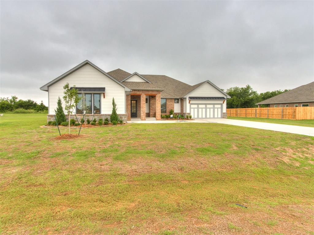 This home offers a spacious layout with detailed finishes throughout. The entry hall leads into an open living room featuring a fireplace, built-in shelving, and large windows. Twelve-foot telescoping glass doors open to a covered patio, extending the living area outdoors.The kitchen includes floor-to-ceiling cabinetry, quartz countertops, floating wood shelves, under-cabinet lighting, a decorative vented hood, stainless steel built-in appliances, an island, and an oversized pantry. Wood-look tile flooring is installed throughout the main living areas.The primary suite features a loggia connecting the bedroom, bathroom, and a study space. The bathroom includes a freestanding soaking tub, a walk-in tiled shower, dual vanities, an enclosed water closet, and a walk-in closet with a windowThis home provides five bedrooms, four-and-a-half baths, and a three-car garage with approximately 3,264 square feet. Energy-efficient features listed for this plan include low-e windows, radiant barrier roof decking, a tankless water heater, insulated and sealed ducts, and a high-efficiency HVAC system. Additional construction details include engineered foundation review, exterior brick with stone accents (per elevation), LED lighting, and upgraded tile selections.Located on a half-acre homesite within a community that accommodates outbuildings, the property offers access to HWY 9 and nearby amenities.