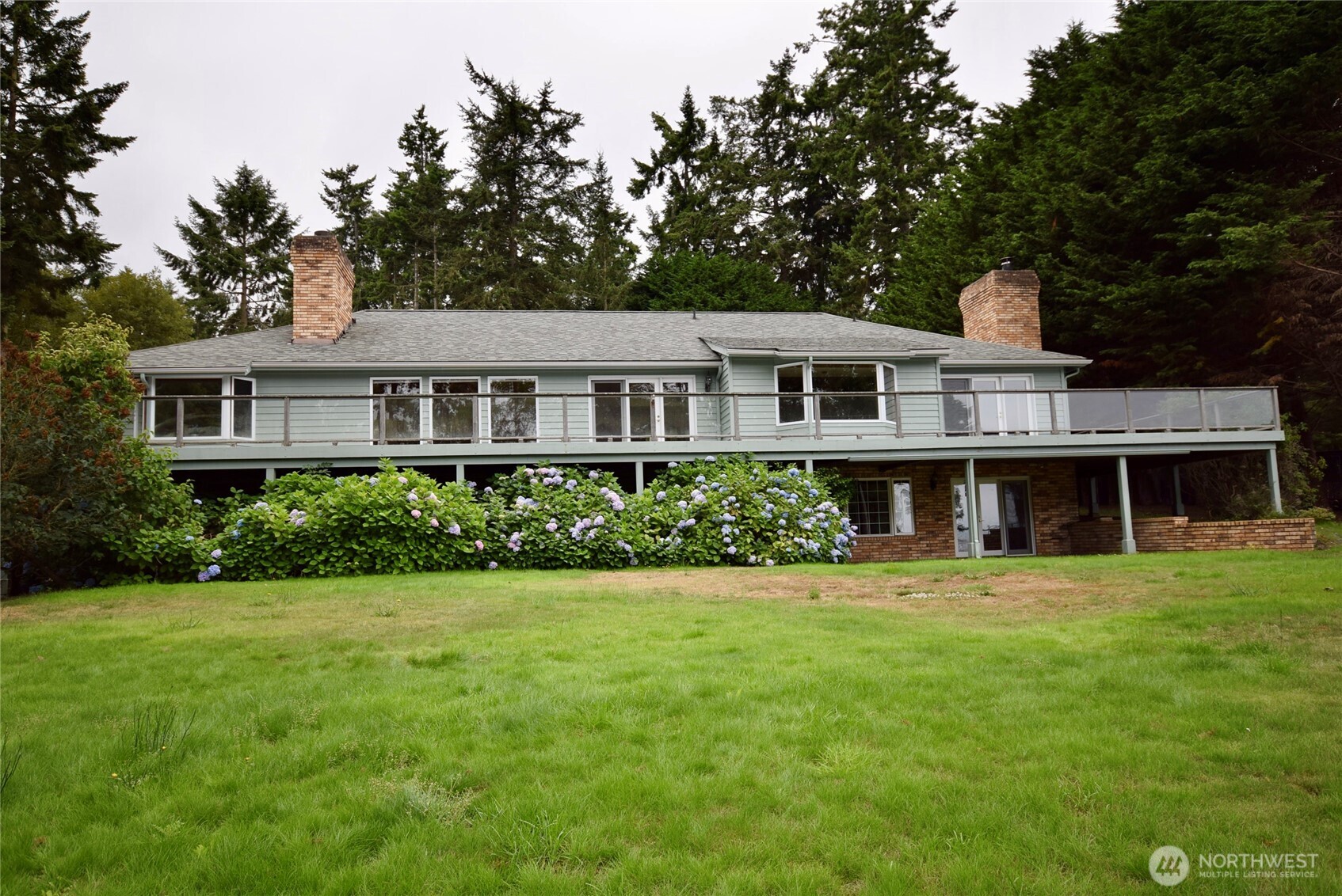 Fabulous 4095 square foot home with 3 car garage on 1.25 acres across from Sequim Bay. Stunning custom wood ceilings with inset logs for a warm, cozy feeling as you relax & enjoy the view. 2 wood stoves & propane fireplace can heat the whole house. Stunning kitchen has granite counters, wood ceilings & eating nook with full windows to the view. 2 formal dining areas, 1 which could be family room. Water view decking across the entire front of house. Extra large primary bedroom has lovely water view, 2 closet areas, bath with tub, custom tile shower & private deck. Downstairs has cozy rec room, custom bar & huge 3rd bedroom with 3/4 bath. Large utility room could be shop/work area. Fully fenced with electric gate, dog run area & outbuilding.
