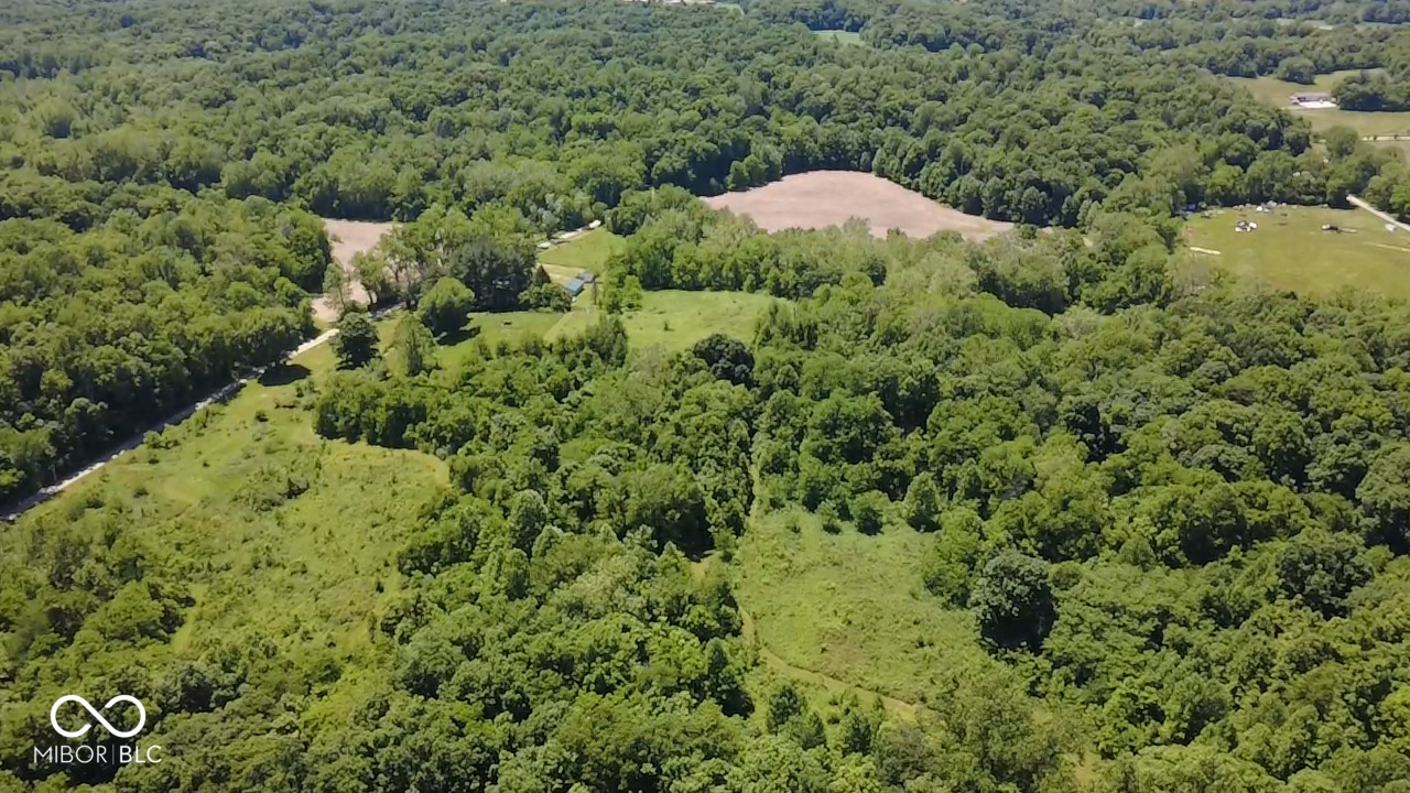 45-Acre Country Retreat with Farmhouse, Tillable Ground, Creek, Hunting & Exceptional Outbuildings! Escape to the peace and privacy of country living with this remarkable 45-acre property offering the perfect blend of farmhouse charm, recreational opportunities, and mini-farm functionality. Whether you're looking for a homestead, hobby farm, hunting retreat, or private family estate, this property delivers endless possibilities. Discover the perfect blend of country living, recreation, and mini-farm potential on this beautiful 45-acre property featuring a 2,189 SF, 2-story farmhouse with 4 bedrooms and 2 full baths. The home offers a main-level primary suite with en suite bath, formal dining room, office, mudroom, laundry room, and a double-sided wood-burning fireplace shared between the kitchen and living room. Three additional bedrooms are located upstairs off the original spiral staircase and loft.  Recent updates include a metal roof (10 years old), new hybrid furnace/heat pump (1 year old), 200-amp electrical service, tankless water heater, water softener, and a reverse osmosis system for the kitchen sink and refrigerator. Outside, you'll find a detached 2-car garage plus an oversized 2-car garage with a potential 5th bedroom, workshop, and storage. Additional features include a chicken coop, livestock shed, two storage sheds, multiple fenced areas for animals, and approximately 10 acres of tillable farmland. Wisener Creek runs through the property, creating a scenic setting with abundant wildlife. Two campsites with fire rings, and neighboring forest-zoned land make this an exceptional hunting and outdoor recreation property.