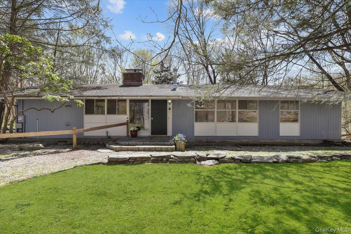 Nestled on just over three acres with a natural setting in the heart of Pound Ridge, this mid-century modern residence has been cherished by the same family for more than twenty-five years. Tucked away at the end of a quiet cul-de-sac, the home offers exceptional privacy and a serene natural setting.This single-level, three-bedroom home presents a rare opportunity to reimagine and elevate a classic design. The spacious living room, anchored by a fireplace, opens seamlessly to an expansive deck overlooking wooded surroundings—perfect for indoor-outdoor living. The kitchen is separate but opens to the dining area, which in turn flows into the cathedral ceilinged living room.The ensuite primary bedroom features its own fireplace, creating a warm and intimate retreat. Two additional bedrooms share a hall bath, while the partially finished basement includes a wood-burning stove and direct outdoor access, offering flexible space for recreation or future expansion.A unique offering with timeless architectural character, ready for its next chapter.