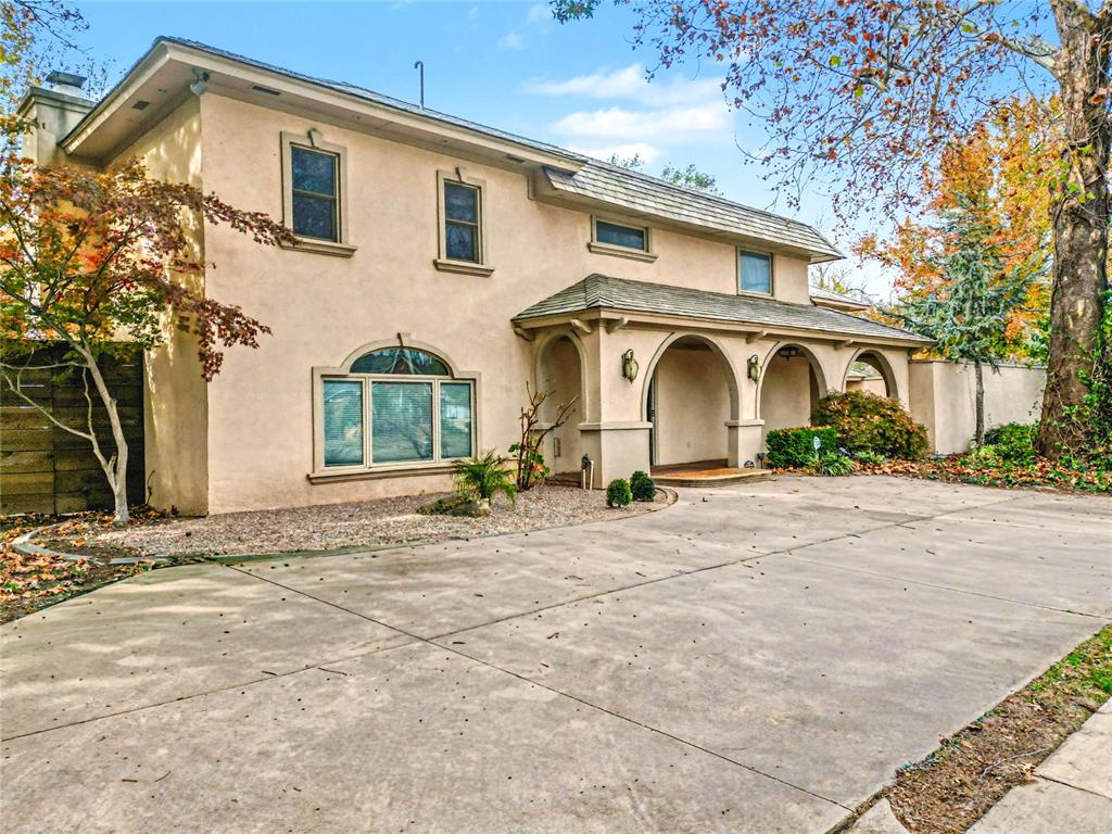 REVAMPED & READY TO SELL! ELEGANT MODERN MEDITERRANEAN ESTATE ON A PRIME CORNER LOT IN BROOKHAVEN ADDITION!  This beautifully designed more than 4,000 sf inspired home sits on a spacious .34 of an corner lot in one of Norman’s most established neighborhoods. From the moment you arrive, the stucco exterior, wraparound covered porch, and private courtyard make a lasting impression. Featuring two driveways & ample parking, the home is perfect for entertaining. Inside, a grand entryway welcomes you with soaring ceilings, a dramatic staircase, and a striking chandelier. The main living area features a floor-to-ceiling stacked stone fireplace, rich built-ins, & wet bar with beverage fridge—a perfect centerpiece for hosting or relaxing. The gourmet kitchen is a chef’s dream with 4-inch granite countertops, bar seating, a commercial-grade refrigerator, breakfast area, & seamless flow into a formal dining room. The first floor offers a private guest bedroom with a full bath, tucked away for comfort & convenience. Upstairs, the primary suite is a true retreat, and is one of the biggest features with it's own living area/office space. The spa-like bath includes heated floors, dual vanities, a jetted soaking tub, separate walk-in shower, & a custom-designed closet with LED lighting, mirrors, & a private laundry room. A loft-style second living area overlooks the foyer, creating a sense of openness. The 2 additional upstairs bedrooms are connected by a stylish Jack-&-Jill bathroom with granite counters, LED mirrors, heated floors, & designer tilework. The backyard offers a private oasis with a concrete pool, Jacuzzi, cedar pergola, and 8-ft privacy fence. The electric gated entry adds both security & curb appeal. Upgrades include an impact-resistant roof, & just across the street, enjoy direct access to a beautiful park with walking trails. A rare opportunity to own luxury, space, & convenience—schedule your private showing today! Buyer to verify schools.