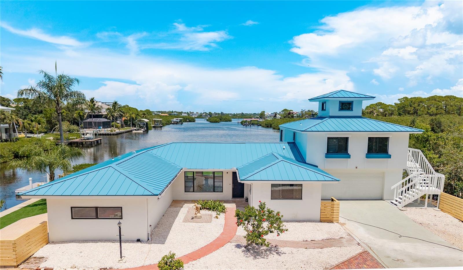Don’t miss this rare opportunity to own a completely updated waterfront home in one of Palm Harbor’s most coveted location, the Ozona corridor! Tucked away at the end of a quiet street, this stunning property is situated on its own private peninsula with water on three sides, offering Million Dollar views and direct Gulf access right from your private dock, perfect for boating enthusiasts. With over 3,300 sq ft of beautifully renovated living space, this home has been lovingly owned by one family since the 1960s and has just undergone a top-to-bottom transformation. Everything is NEW 2025 HVAC, BRAND NEW METAL ROOF, BRAND NEW luxury wood-look vinyl flooring, and a gorgeous designer kitchen featuring a waterfall quartz island, BRAND NEW cabinetry, stylish backsplash, appliances and a dining area that flows perfectly for entertaining. With views like this home has, every seat is the best seat in the house! The split-bedroom floor plan includes three bedrooms and two fully remodeled bathrooms, complete with new vanities, tubs, toilets, and stunning tilework. Need more space or flexibility? The private mother-in-law suite above the garage includes its own full kitchen and private exterior entrance, ideal for guests, rental income, or multi-generational living. Step outside and embrace the Florida lifestyle with a low-maintenance turf lawn, covered outdoor dining area, grilling space, and endless water views. You’ll love spending every evening here, soaking in the sunsets. Located in a golf cart-friendly community, you’re just around the corner from Downtown Palm Harbor, close to Ozona’s local restaurants, and a short ride to Downtown Dunedin’s vibrant dining, breweries, and boutique shopping. Multiple golf courses are just minutes away, and the neighborhood itself is known for being hard to get into, and impossible to forget. Completely renovated. Unbeatable location. One-of-a-kind ownership history. This is more than a home, it’s your chance to live the true Florida waterfront dream.