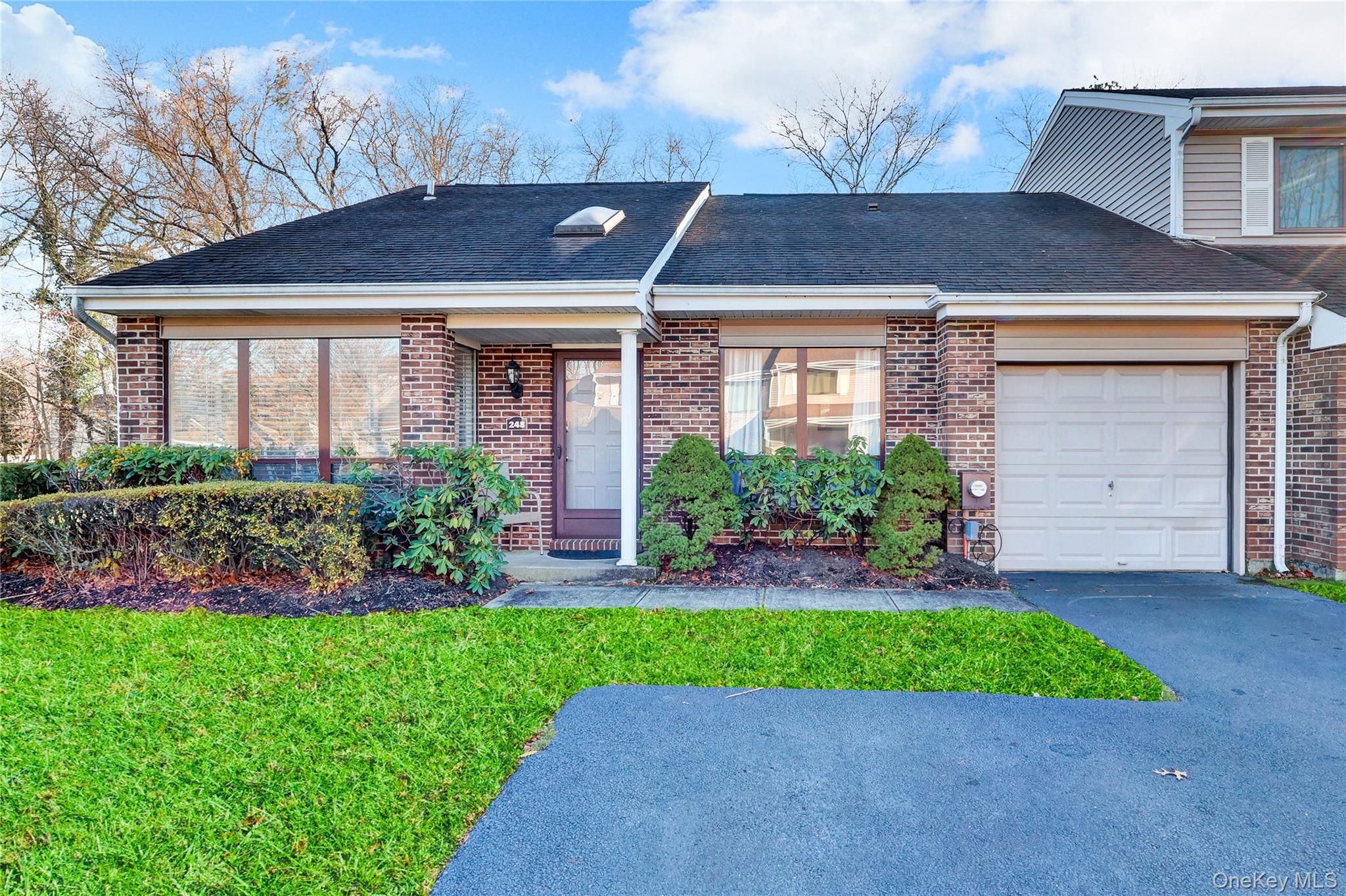 Rare Opportunity In Hidden Ponds! Don't miss this beautifully updated end-unit Emory Ranch. A meticulously maintained, one-story 2 bedroom, 2 bath home in the desirable gated community of Hidden Ponds. Enjoy exceptional privacy with a park-like backyard and the convenience of an attached garage with an oversized driveway.Inside, an eat-in-kitchen with breakfast area is flooded with light from 3 walls of windows, a spacious living room and formal dining room feature an open floor plan with vaulted ceilings, new luxury vinyl plank  flooring  & new LED recessed lighting throughout, with sliders leading to your outdoor living space. A generous primary suite includes a walk-in closet, en-suite bath, and serene views of the rolling lawn. The second bedroom doubles perfectly as a den or home office, offering flexibility to meet your personal needs. Additional conveniences include a hall laundry closet and attic storage.Hidden ponds offers resort-style living with a clubhouse With a shared kitchen, movie/card room, mail room, fitness center, ping-pong, bocce, heated saltwater pool, tennis/pickleball courts, playground, and dog park in this pet-friendly community. Ideally located off 347 for easy access to major roadways, Smith Haven Mall, Main Street Smithtown, and more... Welcome to a community that truly has it all!