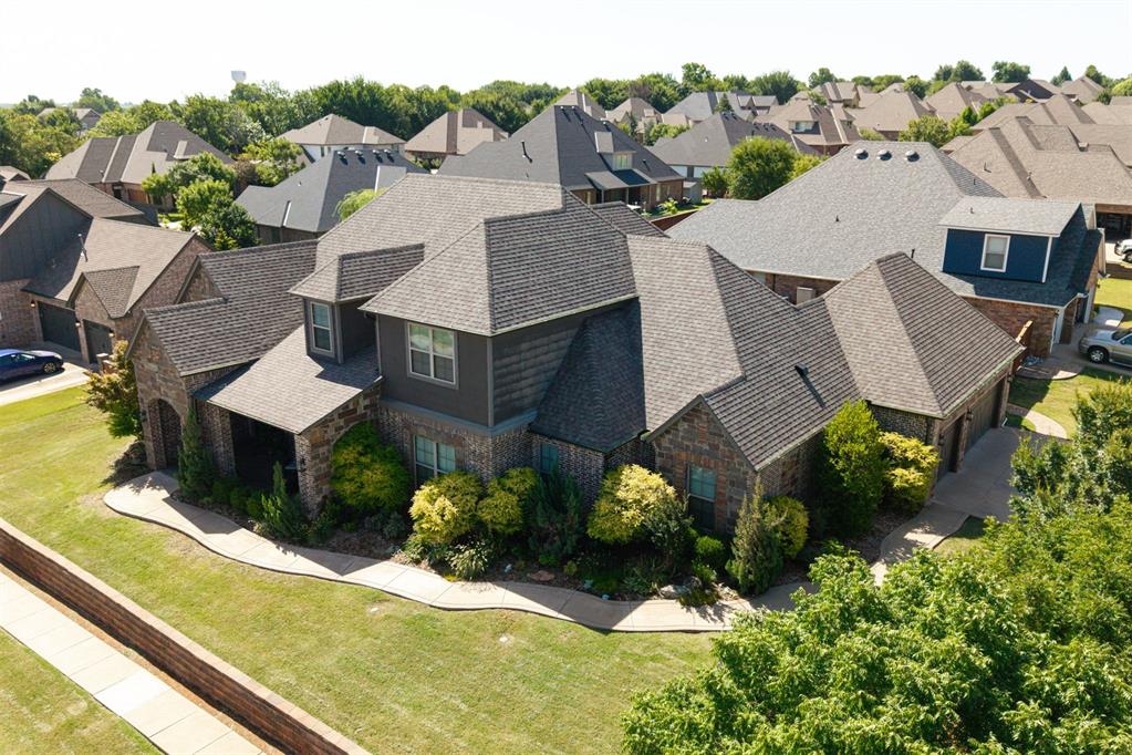 Welcome to 2017 Providence Drive—an exceptional home situated on a spacious corner lot in the highly desirable Hallbrooke community of NE Norman. This move-in ready beauty offers 3,900 square feet of thoughtfully designed living space, featuring 5 bedrooms, 3.5 bathrooms, a dedicated study, media room, and game room. The chef’s kitchen impresses with granite countertops, a massive island, 6-burner gas cooktop with griddle, convection oven, and built-in microwave. Just off the kitchen, you’ll find a private bar with its own ice maker and sink—perfect for hosting.

Comfort meets efficiency with a whole-house geothermal HVAC system, built-in surround sound, and a full security system with cameras that will remain with the home. Step outside and enjoy your personal backyard oasis, complete with a sparkling swimming pool and diving board, relaxing hot tub, outdoor fireplace, and a fully equipped outdoor kitchen with built-in grill.

Hallbrooke residents enjoy access to top-notch amenities, including a beautiful clubhouse, scenic walking trails, private ponds, and a resort-style community pool with waterfalls and lap lanes. Ideally located near I-35, the University of Oklahoma, shopping, and University Town Center, this home offers the perfect blend of luxury, comfort, and convenience. Don’t miss your chance to make it yours!