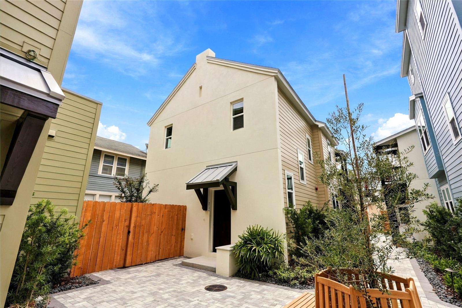 Right in the heart of St. Petersburg’s Grand Central District, this TWO STORY, 2-bedroom, 2.5 bath house with fenced in yard and 1-car garage provides a homey retreat one block off of Central Avenue's local coffee shops, restaurants, bars and small businesses. The ground floor features a living room, a combined kitchen and dining area with built-in storage and a half bath with beautiful designer wallpaper. Just off the kitchen is a private outdoor patio within your FENCED IN BACK YARD. Create a lovely seating area with potted plants, or your own garden. Across your patio you'll find access to your 1 CAR GARAGE. Back inside and upstairs, the primary and secondary bedrooms have their own en-suite full bathrooms and walk in closets. The laundry closet features a full sized side-by-side washer and dryer with extra cabinetry for storage. All four homes at Clemmons Court surround a private residents-only European-style courtyard with private gated entry. This house is the smallest Single Family Home available at Clemmons Court and the only two story home available. Act fast!