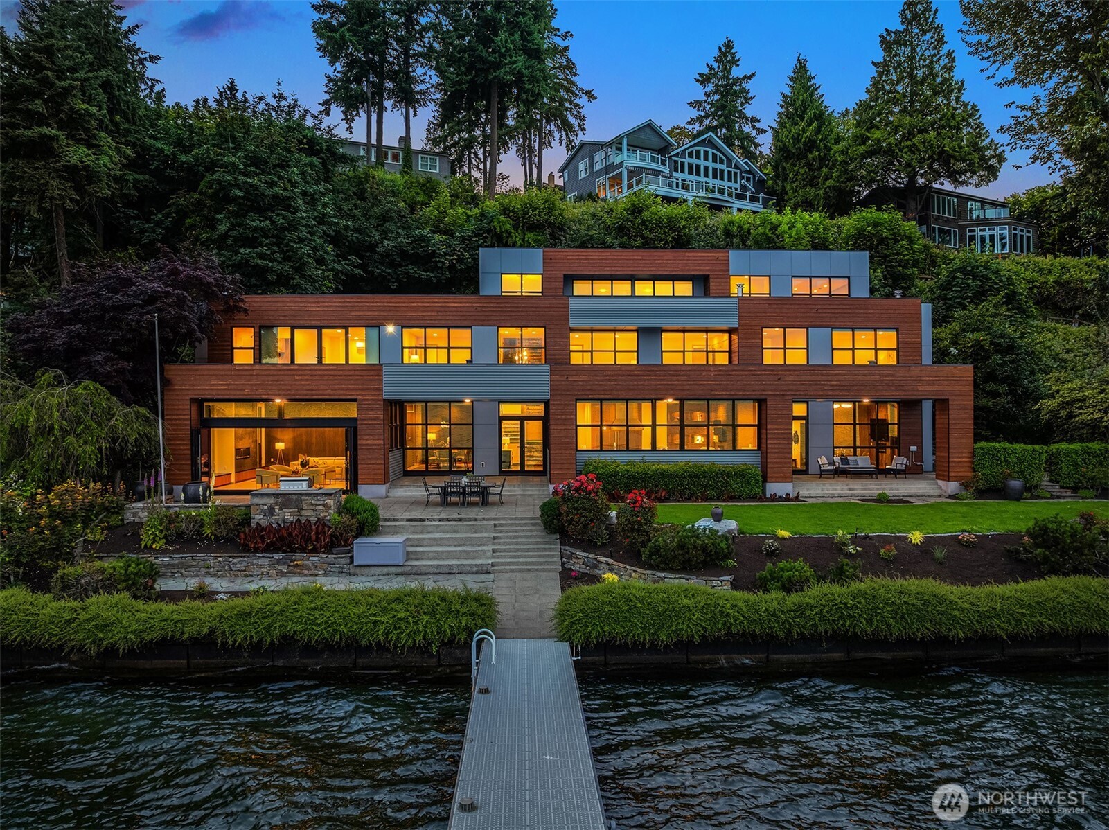Magnificent Modern Waterfront! Custom-built & recently transformed into an elevated lakeside oasis: 154’ prime lakefront, re-decked deepwater dock w/ covered boat lift, built-in BBQ & level lawn. Ideal Northend location – dream commute! Spectacular full remodel w/ gourmet kitchen, updated baths, elevator, new fixtures, lighting, windows, flooring, siding & more. Light, bright spaces w/ clean lines & walls of windows taking in panoramic lake & mtn views from nearly every room. Incredible layout w/ space for all: 4 of 5 BDRs up together incl. luxe owner’s suite w/ private deck & 5-pc bath. 4 more baths+ office & gym/flex 6th BDR. Soaring ceilings w/ nana doors seamlessly connect to outdoor entertaining spaces. Waterfront living at its finest.