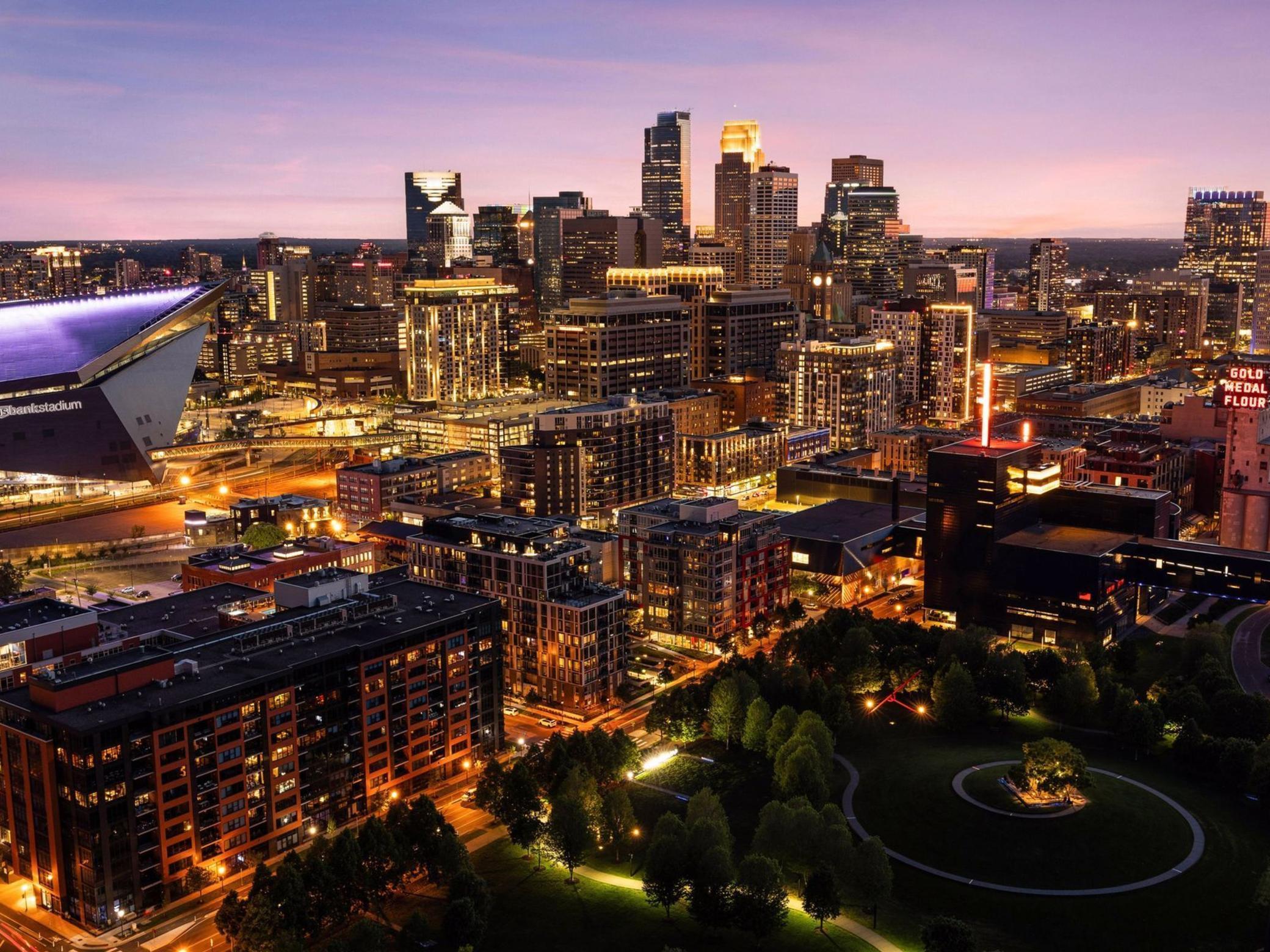 Welcome to ELEVEN, the first residential condominium tower in the heart of Minneapolis by renowned Robert A.M. Stern Architects. Perfectly positioned on the northwest corner of the building, this exquisitely designed two-bedroom plus library, three-bath home boasts unrivaled panoramic views of the Mississippi River, downtown Minneapolis skyline, U.S. Bank Stadium, Gold Medal Park, and the iconic Stone Arch Bridge. From sunrise to sunset, the vistas from this residence are simply spectacular—among the best in the city! Timeless architecture meets refined luxury, with expansive floor-to-ceiling windows that flood the home with natural light. The open-concept layout is anchored by a chef’s kitchen featuring beautiful white oak cabinetry, quartz countertops, Wolf and Sub-Zero appliances, and an oversized center island designed for entertaining. The kitchen flows seamlessly into the dining room with both west and north facing views. The elegant great room includes a striking gas burning fireplace with built-in bookshelves and cabinetry. The spacious primary suite is a sanctuary with spa-like marble bath, soaking tub, separate shower, heated floors, and a generous walk-in center island closet. There is an adjacent private office for reading or working. A 273 square-foot heated, covered terrace extends your living space, offering front-row views of the riverfront landscape. Finishing off the unit is a laundry room, gorgeous powder bath, and lots of storage. Amenities include ten-foot ceilings, oak hardwood floors, enameled woodwork, Sonos wireless speakers, Lutron lighting, eight-foot paneled doors, built-in storage, two heated garage stalls, and much more. ELEVEN delivers an unmatched lifestyle with 24/7 concierge and doorman service, private motor court, library, board room, resort-caliber fitness center, yoga studio, steam and sauna rooms, club room, chef-inspired display kitchen, bar and billiards room, golf simulator and lounge, 75-foot lap pool and hot tub, outdoor kitchens/dining areas/fireplaces, sport court accommodating pickle ball, private dog
 park, on-site car wash and electric vehicle charging stations. This is more than a home—it’s a rare opportunity to own one of the finest condominiums in Minneapolis, where world-class design meets truly unforgettable views. Walking distance to parks, trails, award winning restaurants, shopping and acclaimed theaters.