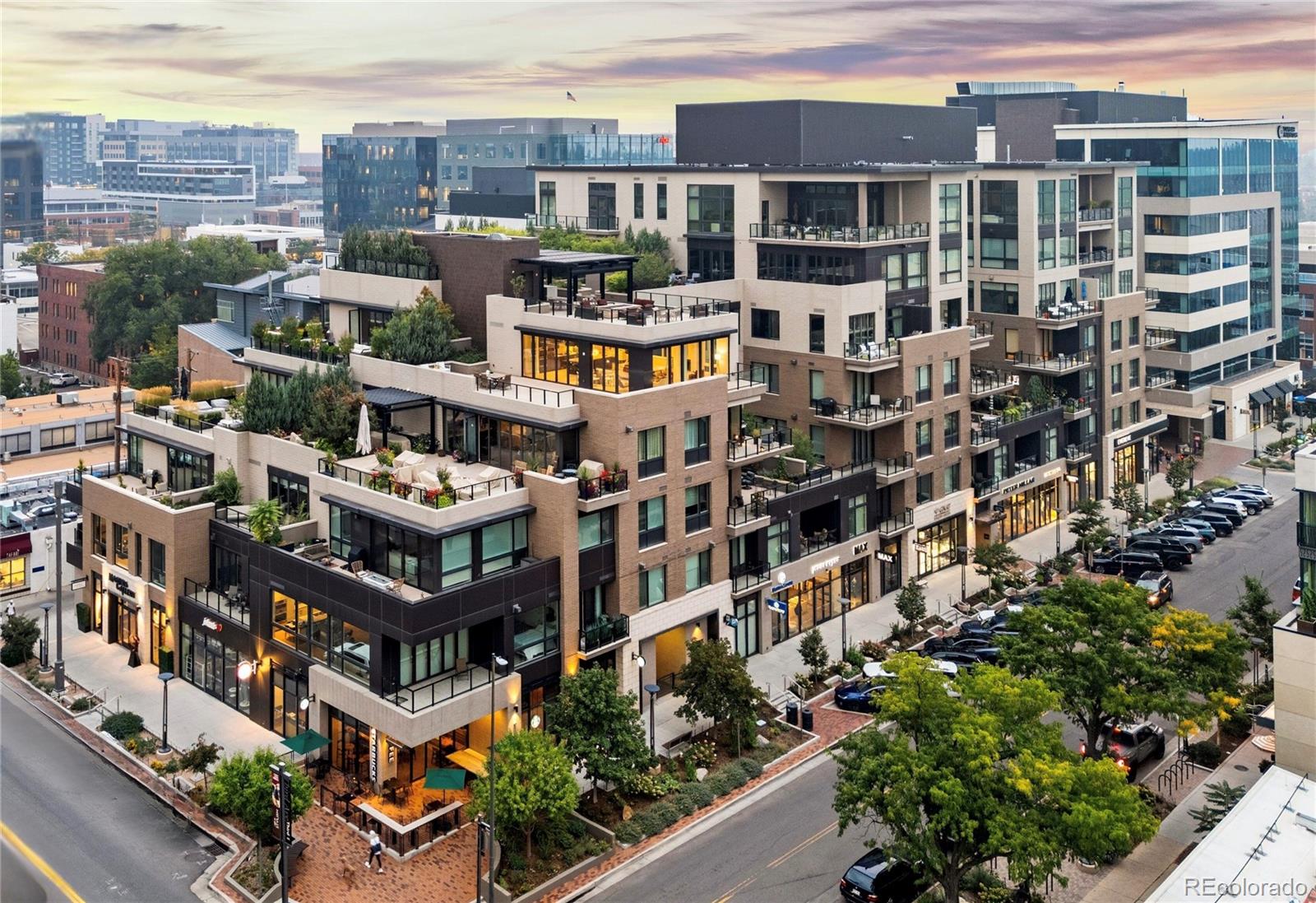 Welcome to Residence 507 at 250 Columbine, a sophisticated southeast-corner home offering 1,459 square feet of beautifully curated living space. From the moment you enter, the residence reveals a harmonious blend of modern design, abundant natural light & refined finishes that define upscale Cherry Creek living. The open floor plan is framed by floor-to-ceiling windows & enhanced by folding glass NanaWall doors, creating a seamless connection between the main living area & private terrace.  A sleek Napoleon ribbon glass fireplace anchors the living room, adding both warmth & architectural elegance. Outside the generous 186-square-foot terrace, is complete with a grill, lounging sofa & firepit—a cozy extension of the home perfect for year-round enjoyment. The large kitchen is a showpiece, featuring top-of-the-line appliances & stunning granite island with ample space for both cooking & gathering. With a separate formal dining space providing an elegant setting for entertaining. The primary suite is a serene retreat, boasting a spa-like 5-piece bathroom with dual sinks, separate soaking tub & custom walk-in closet. The second bedroom provides comfort & privacy for guests, with easy access to a beautifully appointed bathroom. Additional features include hardwood flooring, automatic shades & thoughtful upgrades throughout. A full-sized laundry room, 2 reserved parking spaces & a separate storage locker complete the offering. Residents enjoy premier amenities, including a spacious gym & resort-style rooftop with a plunge pool, outdoor kitchen & lounge areas—offering some of the best views in Cherry Creek. A private lobby & concierge service welcome residents into this enviable address. Just steps away from world-class dining, luxury boutiques & art galleries of Cherry Creek North, Residence 507 offers a lifestyle defined by sophistication, comfort, and unmatched convenience.