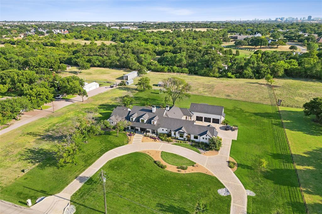 Experience the perfect blend of luxury, privacy and resort-style living at 7851 Meadow Hill. An
incredible custom estate on nearly 5 Ag-Exempt acres! Upon arrival, you’re welcomed by a
beautifully upgraded $14K front porch, a charming circle drive & French doors that
give a first look into the home’s sophisticated interior. Newly renovated chef’s kitchen is a
standout, featuring double islands for seating and prep, a top-tier 6-burner KitchenAid range &
Sub-Zero built-in fridge, KitchenAid appliances & stunning antique mirrored cabinets. The
walk-in pantry stores a second fridge, prep sink & dishwasher, ensuring effortless
entertaining. Dining room is the perfect hosting spot with portrait windows & designer
lighting. Designed for entertaining or family nights, the formal living offers an open layout
with a striking floor-to-ceiling stone fireplace, and abundant natural lighting
from grand windows. The downstairs also features a large media room with plush carpet &
built-in speakers. The gorgeous primary is a private retreat, showcasing a brick accent wall,
vaulted ceiling & stunning backyard view, with a hidden safe room. The primary
bath has been enhanced with a soaker tub, rain shower and quartz vanities. Each of the five
additional bedrooms offers an en-suite bathroom & high-end finishes. The mother-in-law suite includes a separate living space and a vaulted ceiling. Some
unique additional features include a built-in pet spa & kennel, homework nook, large utility
room, two mud areas & a walk-in attic for even more storage! The garage can hold
five cars & includes epoxy flooring and a utility sink. Step outside to the outdoor oasis offering
a resort-style pool and hot tub, lounge chairs, and water features. Fully equipped outdoor
kitchen with two sinks, a Green Egg and bar seating  makes hosting effortless while the covered
patio with vaulted ceilings, built-in speakers and outdoor fireplace ensures you can enjoy it all year long.