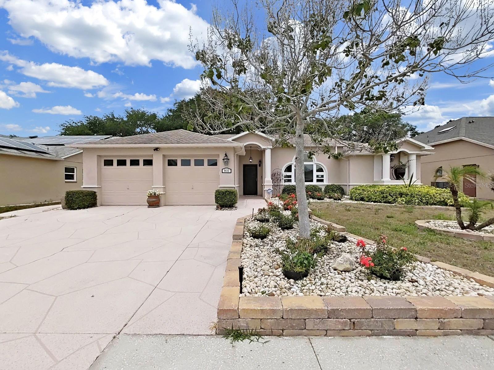 OMG! This family Pool Home is Ready for summer fun! Situated in Hudson’s Fairway Oaks community it is move in ready following extensive renovations completed in 2021. The interior features a modern, light and bright look with updated flooring, fresh paint, can lighting, and a fully remodeled kitchen boasting granite countertops and premium stainless steel appliances. Organization is prioritized in both the kitchen and the primary suite, which feature custom drawer-base cabinetry equipped with chrome pull-out baskets for easy storage. Functional upgrades include a high-efficiency 16 SEER, 3-ton HVAC system installed in 2021 and a new hot water heater replaced in 2023. Further enhancing the home's efficiency and value is a $33,000 investment in 11 energy-efficient windows and 6 exterior doors replaced in 2020-2021.The home offers a spacious three-bedroom, three-bathroom floor plan characterized by airy vaulted ceilings and ceiling fans throughout. The exterior is equally impressive, situated on a lush .24-acre lot that borders a walking trail owned by the HOA—offering privacy with no immediate rear neighbors. The outdoor living space features an enlarged screened porch and a solar-heated pool with a dedicated pool-access bathroom. Replaced in 2011 with a durable peel-and-stick underlayment, the roof remains in excellent condition.  Located in a non-flood zone with low HOA dues, no CDD fees. This home provides exceptional value and is conveniently located near schools, medical facilities, and premier shopping.
