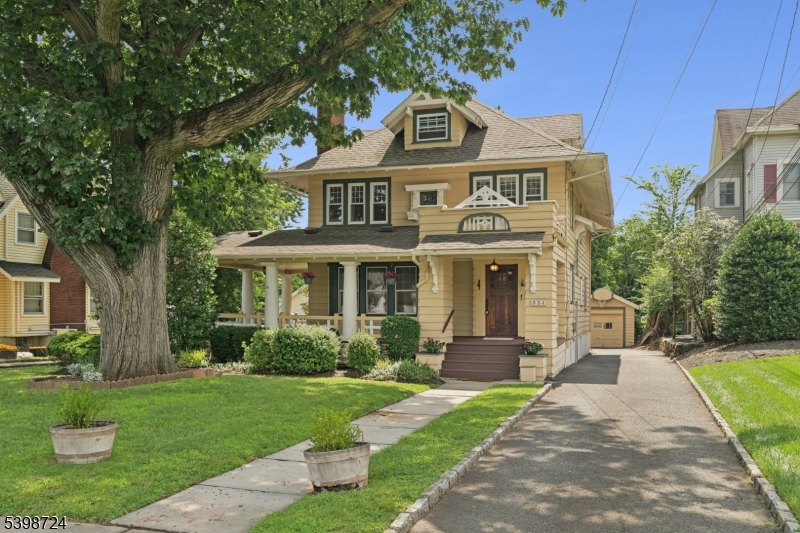 LOCATION, CHARM & SPACE! Just two blocks from vibrant Downtown Westfield, this spacious 5-bedroom, 2.5-bath home blends 1920s character with modern comfort. Enjoy the wraparound front porch or relax on the back deck perfect for outdoor dining and barbecues. Inside, you'll find rich chestnut trim, stained glass accents, a cozy living room fireplace, dining room window seat, stunning inlay hardwood floors, and a box beam ceiling that adds warmth and elegance. The eat-in kitchen opens directly to the deck through sliding glass doors, making indoor-outdoor living easy. Upstairs features four bedrooms on the second floor, plus a flexible fifth bedroom or office on the third. Ample closets, a partially finished basement with side-door access, and a garage with both car and storage space add practicality. Zoned for professional use, this special property is just steps to top-rated schools, the train, shops, and restaurants an exceptional opportunity in a truly unbeatable location.