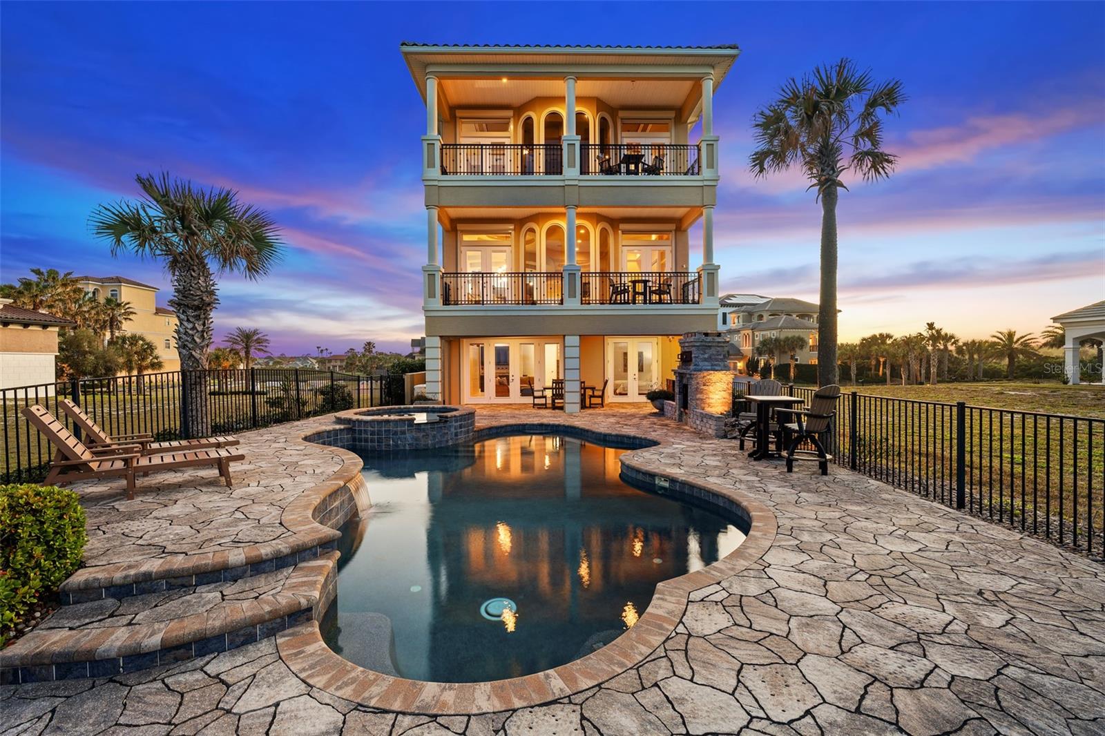 Enjoy truly spectacular oceanfront living with sweeping views of the Atlantic Ocean and the 9th hole of the Jack Nicklaus Signature Ocean Course from this exceptional 3-story  residence in the exclusive Ocean Hammock community.Designed to capture the views from nearly every vantage point, this 4-bedroom, 4-bathroom home with over 4,300 square feet offers an elevated coastal lifestyle. The spacious primary suite is a private retreat featuring a balcony overlooking the ocean and golf course, fireplace, wet bar, and a spa-inspired bathroom, all perfectly positioned to take in the sunrise.An elevator and elegant spiral staircase provide seamless access to each level, while expansive impact glass windows and doors fill the home with natural light and frame the breathtaking surroundings. The kitchen is well-appointed with generous storage, upgraded appliances, and seating ideal for entertaining.Outdoor living is just as impressive, with a pool and spa overlooking the ocean, an outdoor fireplace, and multiple balconies designed for relaxing or hosting while enjoying the coastal breeze. For those seeking an expanded estate setting, the adjacent homesite at 8 Hammock Beach Court is also available, presenting a unique opportunity to secure additional space and privacy in one of Hammock Beach’s most desirable locations. Offered separately.Additional highlights include multiple wet bars, abundant storage, generator, hurricane shutters, and main-level laundry room. Located within the gated Ocean Hammock community, residents enjoy private beach access and optional membership to Hammock Beach Resort, featuring world-class golf, dining, fitness, and resort-style amenities.This is a rare opportunity to own a home that perfectly blends luxury, views, and lifestyle.  Hammock Beach Resort where oceanfront living meets championship golf.