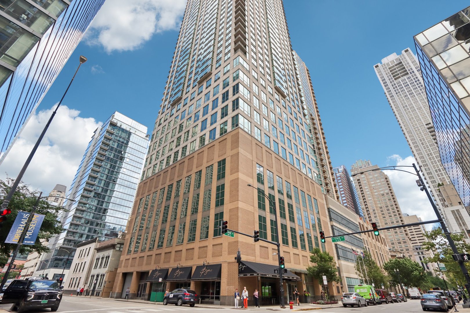 Experience elevated living in the heart of River North. The coveted 03 tier showcases sweeping skyline views and unparalleled square footage at this price point. Step inside and be welcomed by a dramatic foyer leading into a light-filled living and dining space framed by floor-to-ceiling windows.  The residence offers two oversized bedrooms with incredible storage, including a lavish primary suite that feels like its own private retreat-complete with an enormous walk-in closet, spa-inspired bath, and flexible space ideal for a home office or sitting area. The two bathroom floors are heated with timers. Steam shower with multiple shower heads heads in primary bath. Wet bar. Custom mill-work throughout. Large wine cooler and new large washer and dryer. This full-amenity building delivers the ultimate lifestyle with 24-hour door staff, a state-of-the-art fitness center, and a spectacular 40th-floor sundeck perfect for entertaining against the city skyline.    Live above it all in one of Chicago's most vibrant neighborhoods.