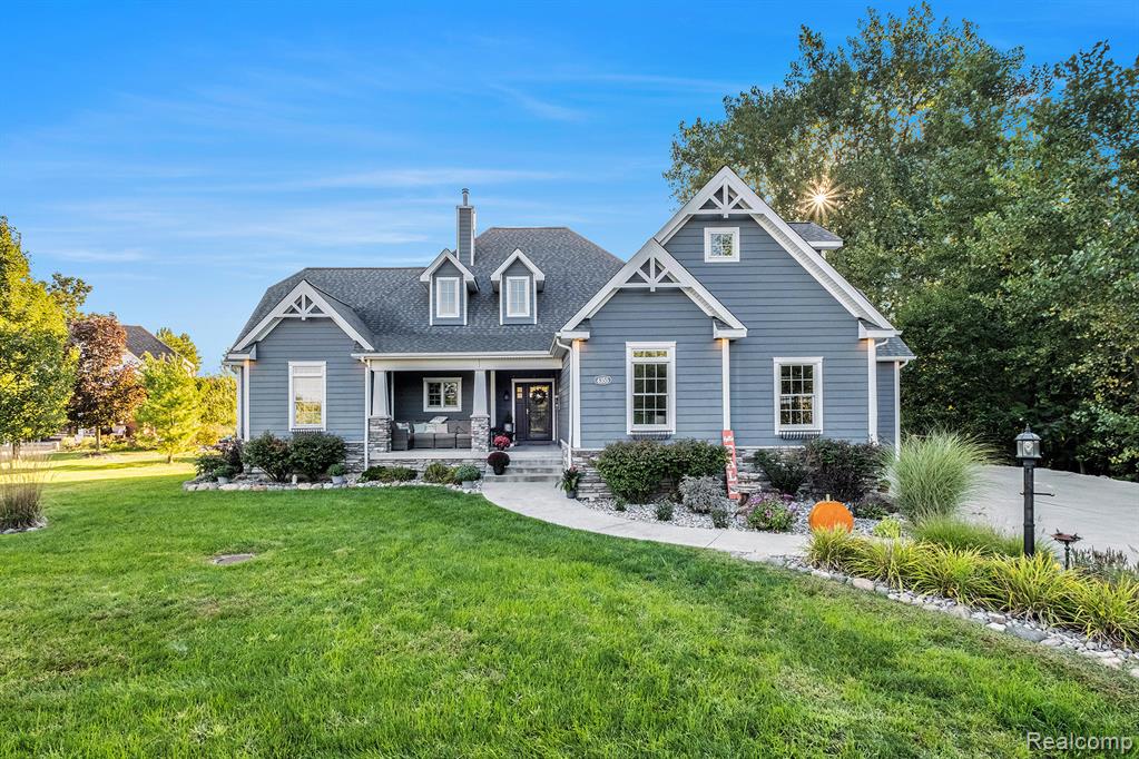 Discover lakeside living at its finest with this custom 5-bedroom, 3.5-bath residence offering 210 feet of pristine frontage on Tupper Lake. Nestled at the end of a quiet cul-de-sac, this home blends striking curb appeal with a thoughtfully designed interior that captures both style and functionality. The main level showcases soaring ceilings, expansive windows that flood the space with natural light, and an open-concept design that seamlessly connects the living, dining, and kitchen areas. The kitchen is a true centerpiece with granite countertops, matte stainless appliances, and abundant storage. Gorgeous flooring and refined finishes extend throughout, while spacious walk-in closets add convenience. Entertaining is effortless with a finished walkout basement featuring a wet bar, leading to a covered patio and the lakefront beyond. Outdoor living continues with a deck overlooking the water, lush landscaping, and a welcoming covered front porch. Additional highlights include a 3-car garage, high ceilings throughout, and a smart layout designed for everyday comfort. Whether enjoying peaceful mornings by the water or hosting lively gatherings, this home delivers an unmatched lakeside lifestyle.