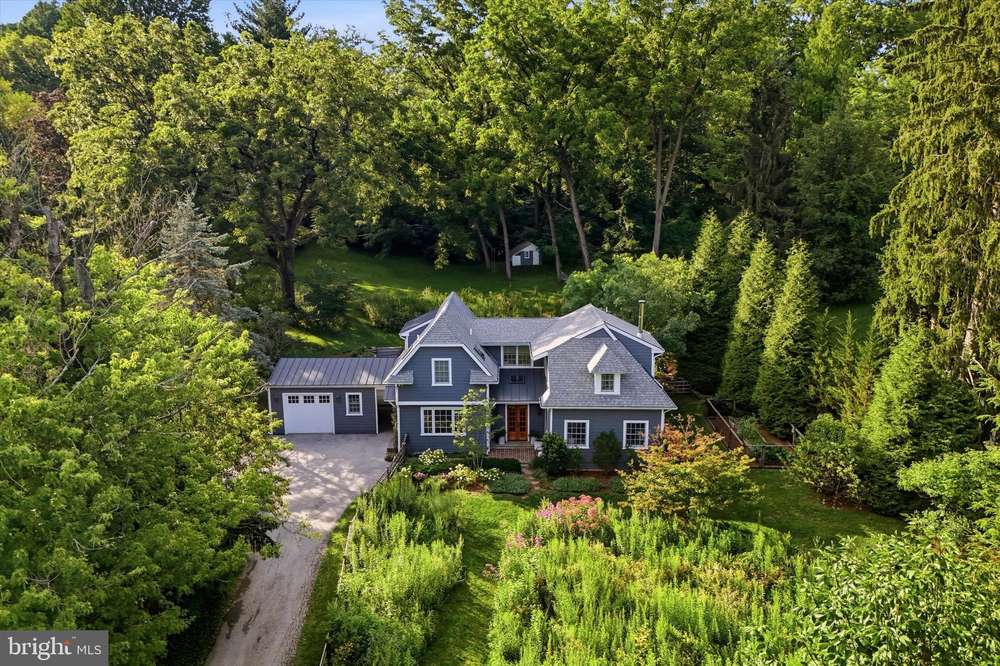 Welcome to 522 Sprague Rd in Villanova; a unique and exceptional property in numerous ways. This 100+ year old carriage house has been renovated with exquisite detail by well-regarded Main Line architects, builders and landscapers. Situated on approx. one acre, the home is set back from the road, behind a fenced in front yard planted with a mature meadow of native plantings. The driveway leads to the garage attached to the home through a covered passage. Enter the home through a sunlit front hall that flows into the living room and kitchen. The kitchen is well-appointed with a cooking work area, pantry storage and island bench seating. High end appliances and finishes such as a hand painted European tile backsplash offer an authentic yet elevated carriage house aesthetic. The kitchen opens into an informal dining and family room that extends to a back stone patio through French doors. The kitchen and family room also extend to a half bathroom and spacious mudroom by the backdoor. The living room is in the front of the house offering an inviting seating space with three walls of UV protectant glass windows and a wood burning stove. Behind the living room is a first-floor bedroom and full bathroom that extends to the back patio.  Upstairs are two spacious bedrooms, each with a bonus room that could be used as an office or nursery along with ample closet space. One bedroom has enhanced features such as a vaulted ceiling, full ensuite bathroom and a Juliet balcony that over looks the very private backyard. A hall full bathroom and a laundry closet complete the second floor.  Recent upgrades to this property are substantial and numerous – including tankless hot water, new windows and doors, and geothermal heating and cooling.From the back patio, stone steps lead up to a private and substantially sized backyard. So private is the yard, you could forget you are actually in the heart of the Main Line minutes from everything. Make this enchanted oasis in Radnor School District your home. Convenient all the Main Line has to offer, award winning schools, parks, transportation routes, Radnor Valley CC, Overbrook CC and more.