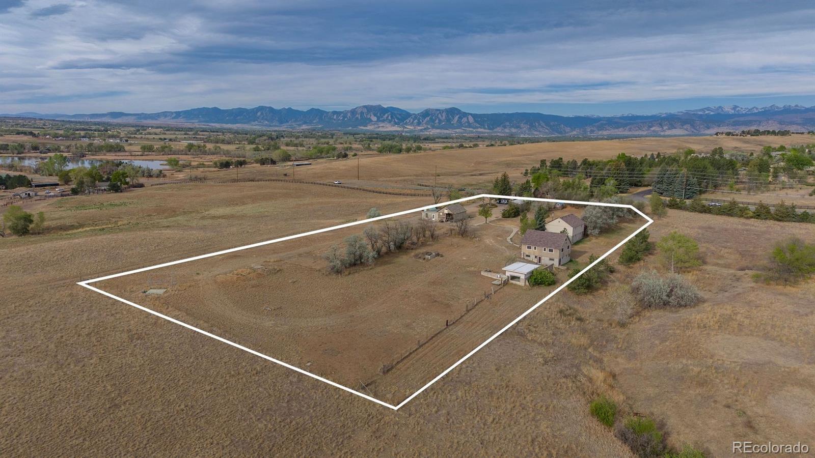 A Boulder County compound with structure, land, and a clear path forward. Positioned on 3.68 acres along the 95th Street corridor between Lafayette and Boulder, this multi-structure property offers a rare combination of immediate livability and long-term optionality. The site includes a primary residence, guest house, and a collection of additional buildings that support a wide range of uses: residential, workspace, storage, creative production, or small-scale agricultural applications (buyer to verify zoning and permitted uses). The main home and guest residence are both livable today, allowing for immediate occupancy while future plans are considered. Beyond the primary living spaces, the property has a dedicated meeting space, private office, barn with finished guest rooms, and additional outbuildings. Each structure serves a purpose, forming a layout that is increasingly difficult to replicate in Boulder County. For buyers seeking more than a single residence, the opportunity lies in how the property can evolve. A current feasibility study is available documenting the site layout, existing structures, and potential paths for improvement or reconfiguration. Early indications suggest that targeted enhancements, such as extending water access to select structures, may offer meaningful increases in usability without requiring complex permitting (buyer to verify). The setting itself reinforces the value: privacy, open space surroundings, and proximity to Boulder, Lafayette, and regional trail systems. This is a location where land, flexibility, and long-term vision carry a premium. This offering is best suited for a buyer who understands how to evaluate property beyond surface-level finishes, someone who sees the advantage in existing infrastructure, separation of space, and the ability to create a highly personalized compound over time. A rare opportunity to step into a property that is functional today, and far more than it appears at first glance.