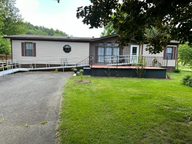 Home with Beautiful Yard Close to New River. This 3 bedroom, 2 bath manufactured home has a wood burning fireplace, open living area and laundry room. There is a broad, open deck on the side and back of home and a nice, big front porch on the front. The yard is big and full of beautiful, mature shade trees. There is an outbuilding for storage an open area that could be used for a garden. This property is located in close proximity to the town of Independence VA and town of Sparta NC.