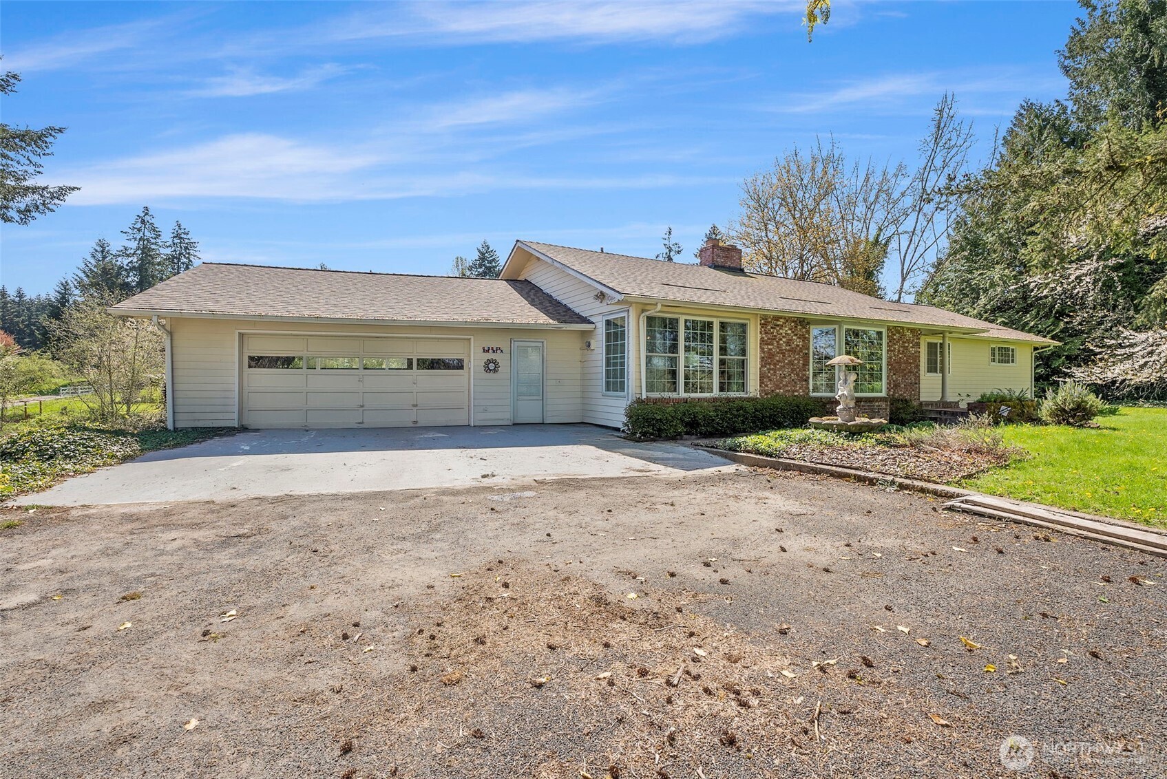 Stunning 4-bedroom, 3-bathroom home offering 4180 sq ft of versatile living space. The main level features a generous primary suite with a private sitting room, formal dining, double living room and an office. The daylight basement has a second kitchen—perfect for multigenerational living or guest accommodations. Two additional bedrooms, a bathroom, finished storage room and a multi-use space. Recent upgrades include Leaf Guard Gutters, Anderson windows and roof replacement within the last three years. Enjoy serene territorial views from nearly every room and relax by your private pond nestled at the back of the 3.14-acre property surrounded by fruit trees. Located at the end of a quiet drive, this home offers peaceful privacy.