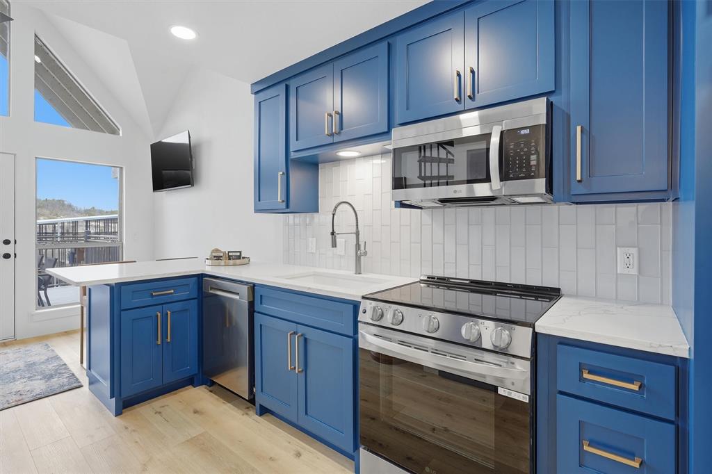 Ultimate lakefront retreat, do not let the size fool you! This thoughtfully designed property offers everything needed for the perfect weekend getaway. Featuring 2 bedrooms, 3 bathrooms, and a dedicated laundry area, the home was completely rebuilt from the ground up in 2025.Being sold fully furnished for true turn-key convenience. Enjoy two patios with beautiful lake views, perfect for relaxing or entertaining. Located just steps from the water with direct access to Bluff Creek Marina and access to a resort-style community pool. The perfect lock-and-leave lake escape.