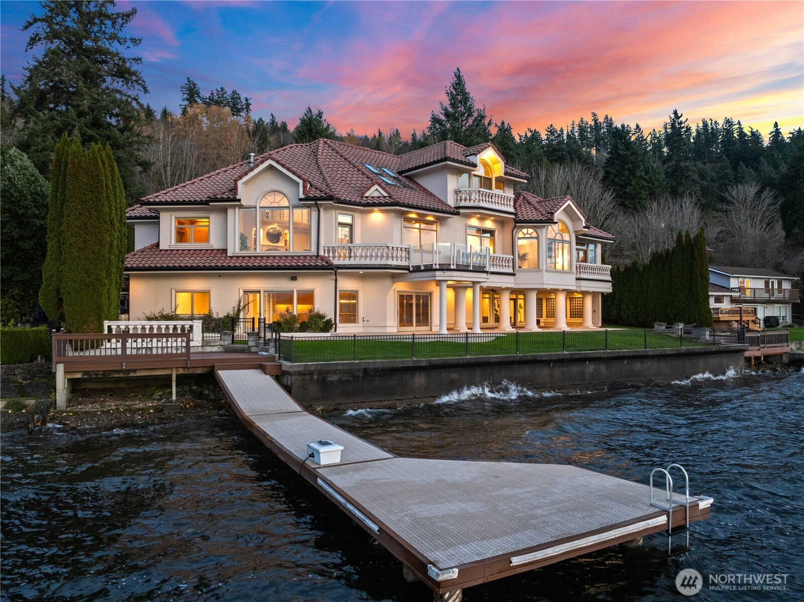 Along 120’ of Lake Sammamish shoreline, this gated waterfront estate blends modern ease with an irresistible connection to the water. Sunlight pours through arched windows, catching the rhythm of tumbling waves and the lake’s soft shimmer. Thoughtfully updated living spaces flow with ease—two contemporary kitchens, a lake-level entertaining hub with a bespoke wine wall, and two-lake-facing primary suites, including a tranquil main-level retreat. Outside, the covered pool, lush lawn, and private dock with boat lift invite inviting refreshing swims, peaceful pauses at the shore, and evenings washed in warm sunset color. Smart-home lighting, security, and audio enhance daily ease. A rare estate where the rhythm of lake life becomes your own.