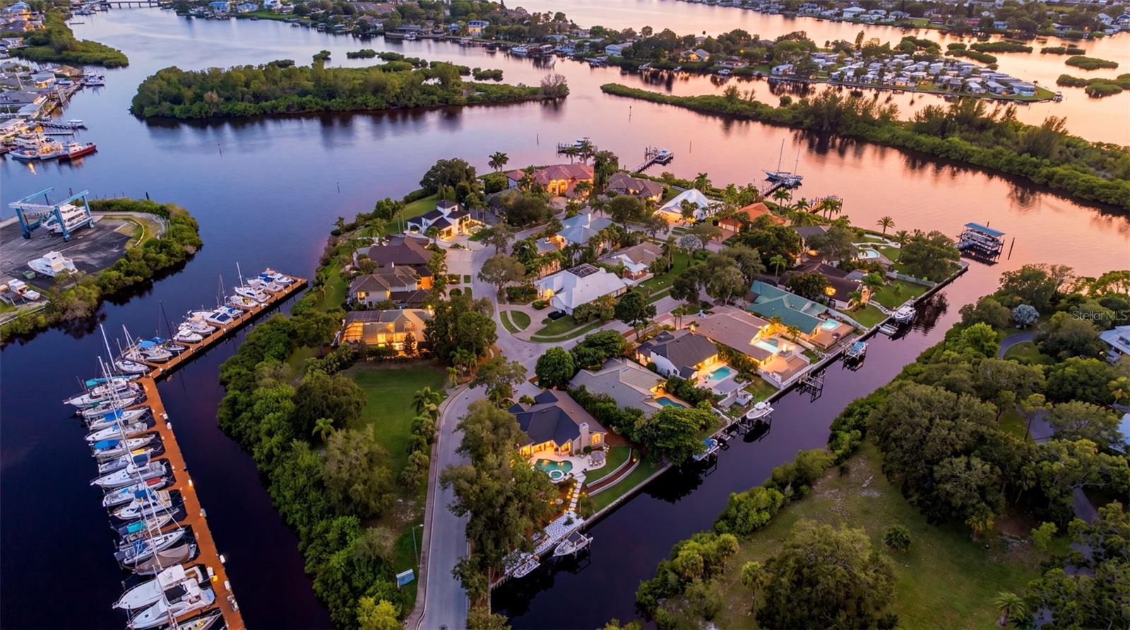 Private island living, nearly half an acre and more than 190 feet of waterfront create an extraordinary setting for this beautifully updated single-story residence in Anclote Isles—one of Tarpon Springs’ most unique waterfront communities, a private island of just 18 homes.Offering exceptional privacy and an impressive setup for boating, the property features multiple boat lifts with no bridges to the Gulf and Anclote Key just a short boat ride away. Its high-elevation (no flood insurance required x-500 zone) setting is another important distinction—the home experienced no flooding from Hurricane Helene.Inside, volume ceilings throughout and abundant windows create a bright, open feel that allows this 3-bedroom, 2-bath home to live larger than its square footage. At the heart of the home, the redesigned gourmet kitchen features extended custom cabinetry, quartz countertops, a dramatic waterfall island and all-new appliances. Overlooking the family room with a wood burning fireplace, casual dining, pool and waterfront, it creates a seamless connection between indoor and outdoor living. Beautifully remodeled baths, new marble flooring in the wet areas, new wide plank white oak flooring, new hurricane-rated windows and doors, and new garage door are among the many additional improvements.Outside, the Florida waterfront lifestyle takes center stage with a pool and spa featuring a new saltwater system and natural gas heater, new travertine decking, an outdoor gym and expansive waterfront views.Just minutes from the historic Tarpon Springs Sponge Docks and a short boat ride to Anclote Key, this is a rare opportunity to own a private waterfront estate combining nearly half an acre, exceptional boating, extensive updates and the exclusivity of one of Tarpon Springs’ most distinctive island neighborhoods.