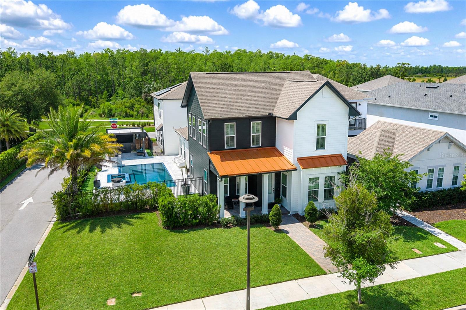 Welcome to luxury living in the highly sought-after community of Laureate Park in Lake Nona.  Close by the brand new Lake Nona West shopping center, this perfectly positioned home is on a premium corner lot with conservation views both in front and behind the home, this exceptional property offers privacy, space, and one of the best locations in the neighborhood.  Enjoy the convenience of being just a short walk from Laureate Park's vibrant town center, Canvas Restaurant & Market, top-rate schools, Heroes Community Park, and Adventure Park.Built in 2020, this beautifully upgraded residence features a spacious 4-bedroom (plus additional office/flex space), 3-bathroom main home designed with both comfort and entertaining in mind.  Inside, you'll find high-end finishes throughout including quartz countertops, closet systems, plantation shutters in every room, upgraded recessed LED lighting, and build-in surround sound.  The home also features a whole-home audio system with five indoor and outdoor zones, allowing you to enjoy music throughout the house and outdoor living spaces.  A stunning custom feature stone wall with an electric fireplace serves as a beautiful focal point in the main living area.Step outside into your private backyard retreat, complete with a stunning zero-edge pool, spa, and a custom pergola-perfect for relaxing evenings or entertaining guests while enjoying serene conservation views.One of the most desirable features in Laureate Park is the 3-car garage and driveway that accommodates three additional vehicles-a rare find in this community.  Above the garage sits a fully appointed garage apartment with its own private entrance, separate bedroom, full bathroom, and washer and dryer.  This flexible space is ideal for rental income, a private in-law suite, or guests.Residents of Laureate Park enjoy resort-style amenities including a fitness center, basketball and tennis courts, and an impressive aquatic center featuring three pools, a splash and play area, and a dedicated lap pool.  High-speed internet is also included in the HOA, adding even more value and convenience.  The home is equipped with solar panels to help reduce energy costs while supporting energy efficiency.Combining luxury upgrades, an unbeatable location, and flexible living space, this home offers the perfect balance of elegance, functionality, and lifestyle in on of Lake Nona's more desirable communities.
