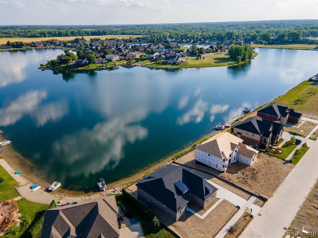 Welcome to highly desired Clear Spring Lake of Shelby Township! Garrett Homes is building sensational estate homes directly on the gorgeous 90 acre lake! From the moment you step inside our 4,370 sq. ft. Chesapeake colonial, you’ll be entranced by beautiful lake views at every turn. (ESPECIALLY ON THIS HOMESITE - PRETTIEST OF ALL VIEWS!!!) The grand foyer extends into elegant living and dining rooms, and also opens wide to a dramatic great room with exquisite 2-story fireplace and a wall of lakefront windows. Entertaining options are limitless with the great room adjoining a spacious gourmet kitchen and bay-windowed nook, allowing guests to seamlessly flow from one room to the other. A secluded study overlooking the lake is a welcomed bonus to the first floor. The impressive owner’s suite includes an awe-inspiring spa bath with dual entrances to an oversized shower, stylish free-standing tub and expansive walk-in closets. A guest suite, two additional bedrooms sharing a jack and jill bath, and a convenient laundry room complete the second floor. An en-suite option for all bedrooms to enjoy private baths is available as well. Finally, a full walkout basement provides the opportunity to create even more quality living space overlooking the lake! 

Features include custom Lafata cabinetry, stainless WOLF appliances, COVE dishwasher, granite counters, hardwood flooring, sensational walk-in pantry, wrought iron staircase and balcony overlooking great room, double front doors, stunning front elevation with brick, stone, double bay, and 2 wing walls, deep walkout basement with extensive windows, doorwall, & prepped for bathroom, oversized 3 car side entry garage.  

HOME IS TO BE BUILT. Build time is approx 18 months.