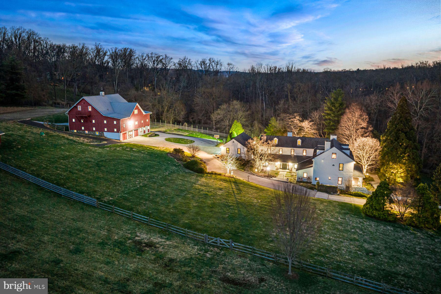 WOW!! This breathtaking 5.9-acre property will spellbind you the minute you pull through the custom crafted entrance gates and take in the expansive, private views of the green lawns, stunning trees, colorful gardens and picturesque historic residence with a fabulous 5-stall horse barn. The beautiful 3.2- acre vacant parcel to the left of the driveway is also available and separately listed for $2,000,000. Rare opportunities like this seldomly present themselves in this coveted enclave of Gladwyne, with these 2 stunning combined 9-acres being available at the same time that 1225 Country Club Road, set on a spectacular 12.65-acre potentially subdividable lot, is also for sale and separately listed for $7,995,000.   The absolutely charming, sun-filled historic home, originally constructed as the Llewellyn Homestead in 1716, was thoughtfully renovated and tastefully expanded in 1992, seamlessly blending all of the original architectural materials, original flooring, walk-in fireplace, millwork and moldings with an open concept floorplan throughout the everyday living spaces.  The timeless gourmet kitchen with eat-in island,  double gas Viking range with 6-burner cooktop, 36" SubZero refrigerator, separate 36" freezer, an enormous walk-in pantry with plentiful shelving and cabinetry, adjacent breakfast room with 2 walls of windows and French doors leading out to the expansive terrace and gardens, an inviting family room off the kitchen with vaulted, beamed ceiling and stone fireplace, two generous offices with built-ins and a spacious mudroom/ laundry room off of the oversized  attached 3-car garage. The gracious foyers, light filled original living room with original wide plank floors, moldings and millwork, open views of the grounds, fabulous library and gracious dining room also flow easily for every day living and easy entertaining. Two staircases lead up to the spacious second floor featuring a spacious primary suite with sitting area with custom built-ins, fireplace, 2 walk-in closets and primary bath with whirlpool tub, oversized shower and double vanity, the second bedroom with bright windows offers an en-suite bathroom and the 3rd and 4th bedrooms share a convenient Jack and Jill bathroom. The charming 3rd floor offers 2 additional large bedrooms with original, restored pine floors  and a vintage style full bathroom with the dry lower level provides flexible finished space for an exercise room or media space as well as lots of storage. There's more!! Seize the rare opportunity to own this incredible home as well as the stately 5-stall horse barn in the rear with breathtaking loft, easy to finish as the ultimate gentleman's equestrian oasis, car collectors showroom or fabulous party barn. The opportunities are endless, all in this coveted, Gladwyne location, close to renowned public and private schools, all forms of transportation, restaurants, shopping, Center City Philadelphia and more!! A true treasure in every way!!.    ** Also available is an absolutely stunning 3.21- acre parcel set to the left side of the gated entrance to 701 Conshohocken State Road.  This lot is only available with the purchase of 701 Conshohocken State Road, totaling, and would offer an overall property size of 9.21 acres. **These two parcels are also adjacent to 1225 Country Club Road, which is separately listed and features a fabulous custom- built residence, stunning out buildings and pool, set on 12.65 potentially sub-dividable  acres. All 3 parcels in totality present a rare opportunity to purchase a breathtaking 21.86 acre estate setting.