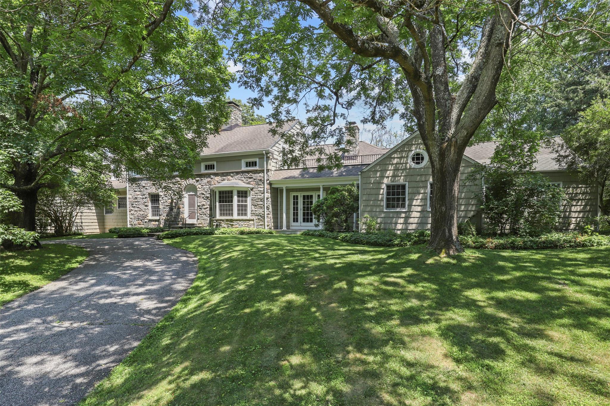 "Sardana" - 
Discover unmatched serenity and total privacy at this wonderful stone and shingle estate, tucked away on 22  acres with a private lake,  2-bedroom guest cottage, and greenhouse.
Set well back from Pine Brook Road, the main residence offers five bedrooms including a ground-floor primary suite. Expansive windows throughout capture views of the lake, flooding the home with natural light and connecting you to the beauty outside.
This is a rare opportunity to own a truly magical setting — peaceful, secluded, and impossible to replicate.