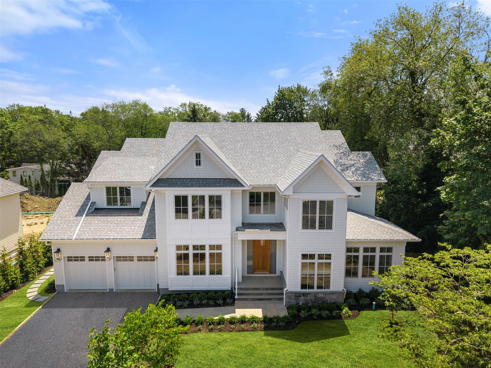 Exclusive New Construction offered by a premier local Scarsdale luxury developer!  This meticulously crafted designer shingle style residence is located in a charming, picturesque Heathcote, Scarsdale neighborhood. set on a half-acre of private property and offers brilliant features.  Main level offers a spacious, natural light filled open concept modern floor plan with living room, family room, and dining room offers flexible use of all entertaining spaces.  Breathtaking sun drenched luxury chef kitchen, with custom inset cabinetry, high end appliances, large island, eating area, pantry, butler/bar area, open flow with large family room, with beamed ceiling details.  Beautiful double sliding glass doors open to a large outdoor covered and uncovered deck area, Study/Library/Music room with vaulted wood ceiling and impressive oak shelving, stunning powder room. mudroom with custom millwork, express laundry, private first floor bedroom en-suite,  Spectacular large entryway with vaulted ceiling, open tread oak stairs to upper level.  Second level offers a private primary suite with a breathtaking cathedral ceiling, dual customized closets and luxurious European spa bath with impressive ceiling details, and a large private balcony, Private en-suite secondary bedrooms customized for different personalities. Large laundry room. Hallway reading/study area with oak built-ins.  Lower level is optimal for entertainment and relaxation with a large recreation room with a bar area, soundproof media room, exercise room, bedroom quarters, and storage.  Oversized insulated, heated garage with EV wiring.  Full walk up attic storage space.  Spacious grounds, private, nestled with exquisite plantings, optimized for entertainment and family enjoyment in a  tranquil outdoor paradise, large open deck, covered porch area, and room for 20x40 pool, Innovative contemporary wall and ceiling finish details throughout this completely turnkey luxury residence.  Designed with passion, built with surgical precision, every high-end feature and unique finishes imaginable, state of the art technology, built with locally renowned architectural and engineering services. Ideal for young growing extended families. Walking distance to Heathcote School, Five Corners, Golden Horseshoe, houses of worship, close to the train station, 35min to NYC.