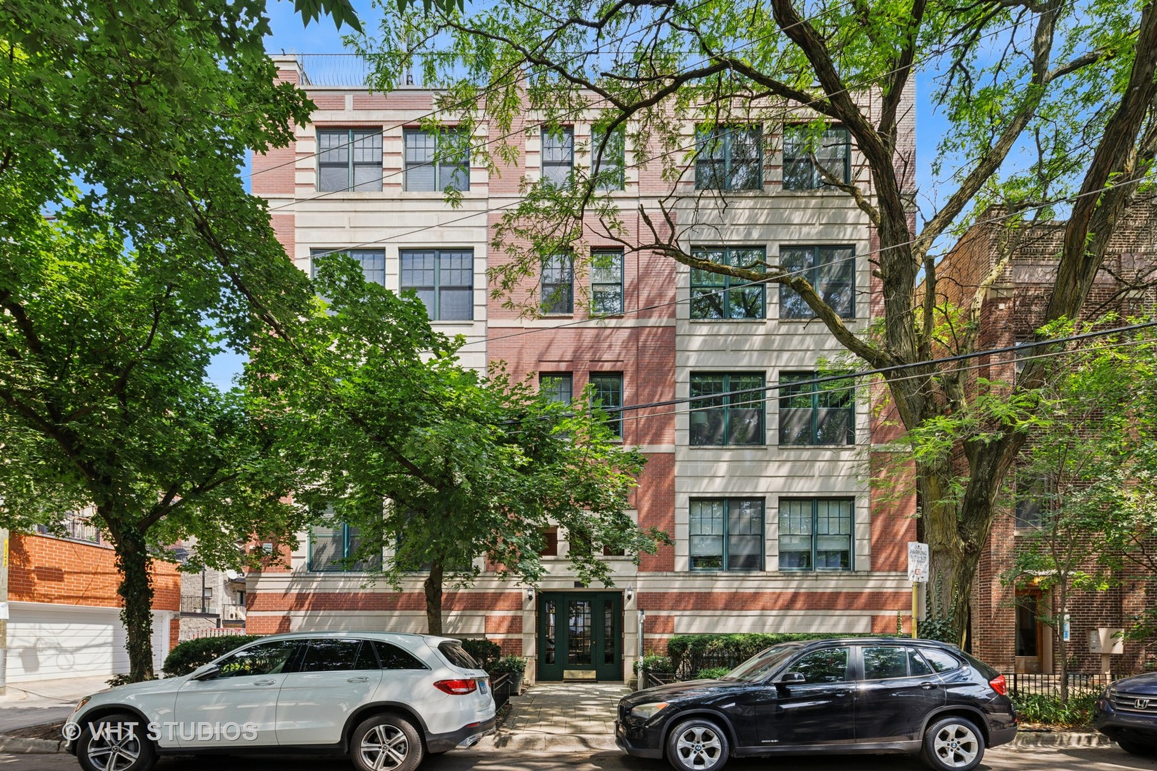 Location AND a bright fabulous condo? Yes please! This rarely available PENTHOUSE unit is flooded with light in an intimate 10-unit well run ELEVATOR building (no walking up dozens of flights of stairs)! The EXTRA WIDE floor plan offers 3 gracious bedrooms and tons of storage space plus an ATTACHED BALCONY in the unit and a PRIVATE ROOF DECK with direct semi-private access and panoramic views! This quiet dead-end street is the perfect nook in East Lakeview (Nettelhorst and Lake View High school districts). Sellers have meticulously maintained this home ...  with Renewal by Anderson windows installed throughout, newer Trane furnace and AC, and Rheem hot water tank - among ALL appliances that have been replaced.  Freshly painted, and hardwood floor refinished recently and in mint condition. The open concept living/dining/kitchen in this extra wide space allows eating for 8 at a table and easily 6-8 more at the long granite counter. The entertainers kitchen features GE Profile stainless steel appliances and solid wood cabinets with modern black pulls and slide-out cabinet shelves.  The living room boasts non-obstructed views of both trees and the city skyline and includes a gas fireplace - perfect for cool nights. The sun-filled primary suite opens to a quaint private balcony plus there is plenty of room for a king bedroom set and an additional seating area. The Elfa-organized walk-in closet, includes pull-out drawers and shelving. The spa-like ensuite bath has a double vanity, soaking tub and separate shower with Moen fixture. Two additional bedrooms have generous Elfa-organized closets, custom wood shelving, Hunter Douglas blinds and access to a full guest bath. This unit even has a separate space for a side-by-side washer and dryer and laundry storage, plus a separate utility storage area, and a large linen closet....so much storage!  Importantly for this vibrant neighborhood, 2 SECURE GARAGE PARKING SPACES ARE INCLUDED. No need to go outside. Take the elevator down to parking (and more storage/shelving). You are in the heart of it all with Mariano's, Trader Joes, Lakeview Athletic Club, Broadway Corridor restaurants and shops, Wrigley Field, the lakefront, bike paths, parks, schools and convenient public transport nearby.