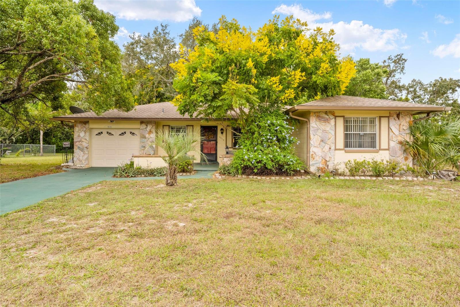Furnished Home – Built in 1981, this charming 2-bedroom, 2-bathroom home with a 1-car garage offers 1,879 total sq.ft. . Recent updates include an A/C (2025), roof (2016), mailbox and fresh interior paint. The kitchen features a stove, range hood, and refrigerator, while the adjoining living/dining combo includes a built-in hutch for added storage. Sliding doors open to a Florida room spanning the width of the home, finished with ceramic tile—perfect as an office, family room, or recreation space. The primary suite features an attached bathroom, while both bathrooms include a convenient tub/shower combination. A laundry area with a washer, dryer, and deep sink is included. The garage offers additional storage. Enjoy outdoor living with a back patio ideal for a table, chairs, and BBQ grill.  A security system is installed for peace of mind. Minutes from hospitals/shopping/restaurants, with quick access to the Suncoast/Veterans Pkwy for an easy 45-minute drive to Tampa and 90 minutes to Orlando parks. The Gulf of Mexico is 15 minutes away!